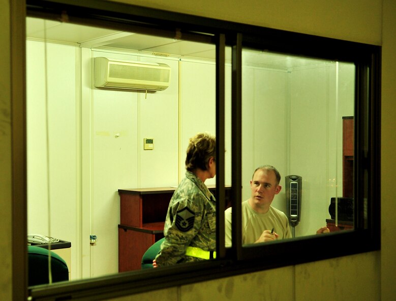 Staff Sgt. Curtis Eccleston, 733rd Air Mobility Squadron special planning supervisor, and Master Sgt. Rita Johnson, a reservist from the 39th Aerial Port Squadron, Peterson AFB, Colo., inspect the load list and cargo manifest before the cargo is transported for loading during Beverly High 10-02 at Kadena Air Base, Japan, March 22.  The 18th Wing is participating in a Local Operational Readiness Exercise March 22-26 to test the readiness of Kadena Airmen. (U.S. Air Force photo/Tech. Sgt. Rey Ramon)    