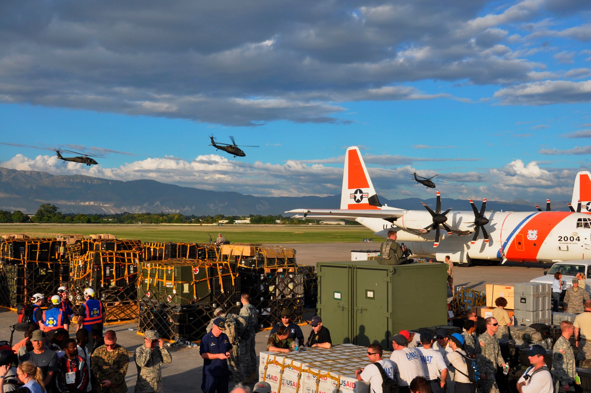 Members of the international aid community work alongside a large joint U.S. military presence during Operation Unified Response at the Toussaint L’Ouverture International Airport in Port-au-Prince, Haiti. Airmen from the 621st Contingency Response Wing from Joint Base McGuire-Dix-Lakehurst, N.J., responded in the aftermath of a 7.0 magnitude earthquake that crumbled most of the surrounding area killing hundreds of thousands and displacing millions from their homes. (U.S. Air Force photo/Capt. Dustin Doyle)