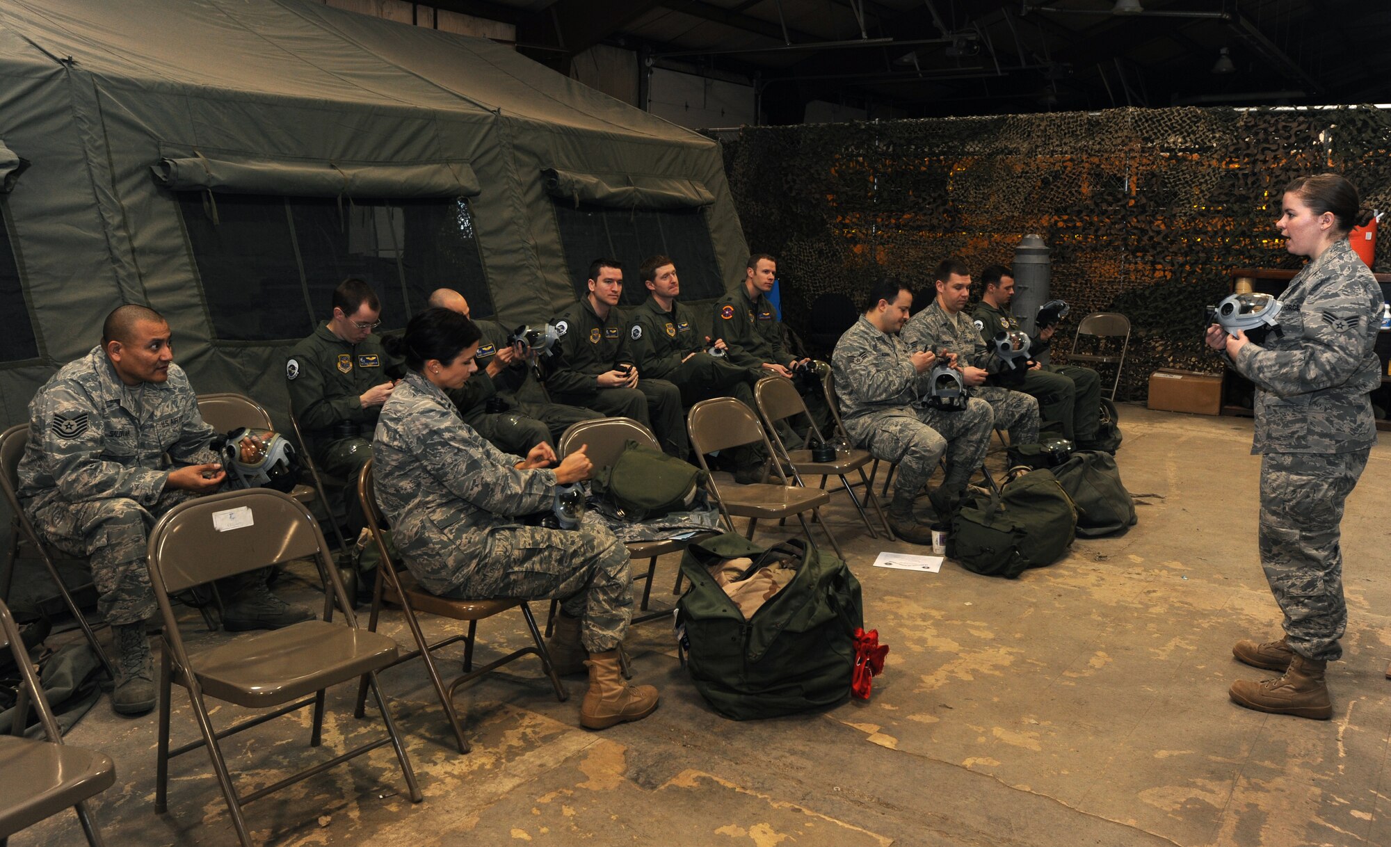 Senior Airman Jilene Botkin, 319th Civil Engineer Squadron, teaches a class on the functions and parts of a MCU-2A gas mask March 18 on Grand Forks Air Force Base, N.D.  Airman Botkin trains Airmen on Chemical, Biological, Radiological and Nuclear contamination, control and avoidance. (U.S. Air Force photo by Airman 1st Class Amber Price)   