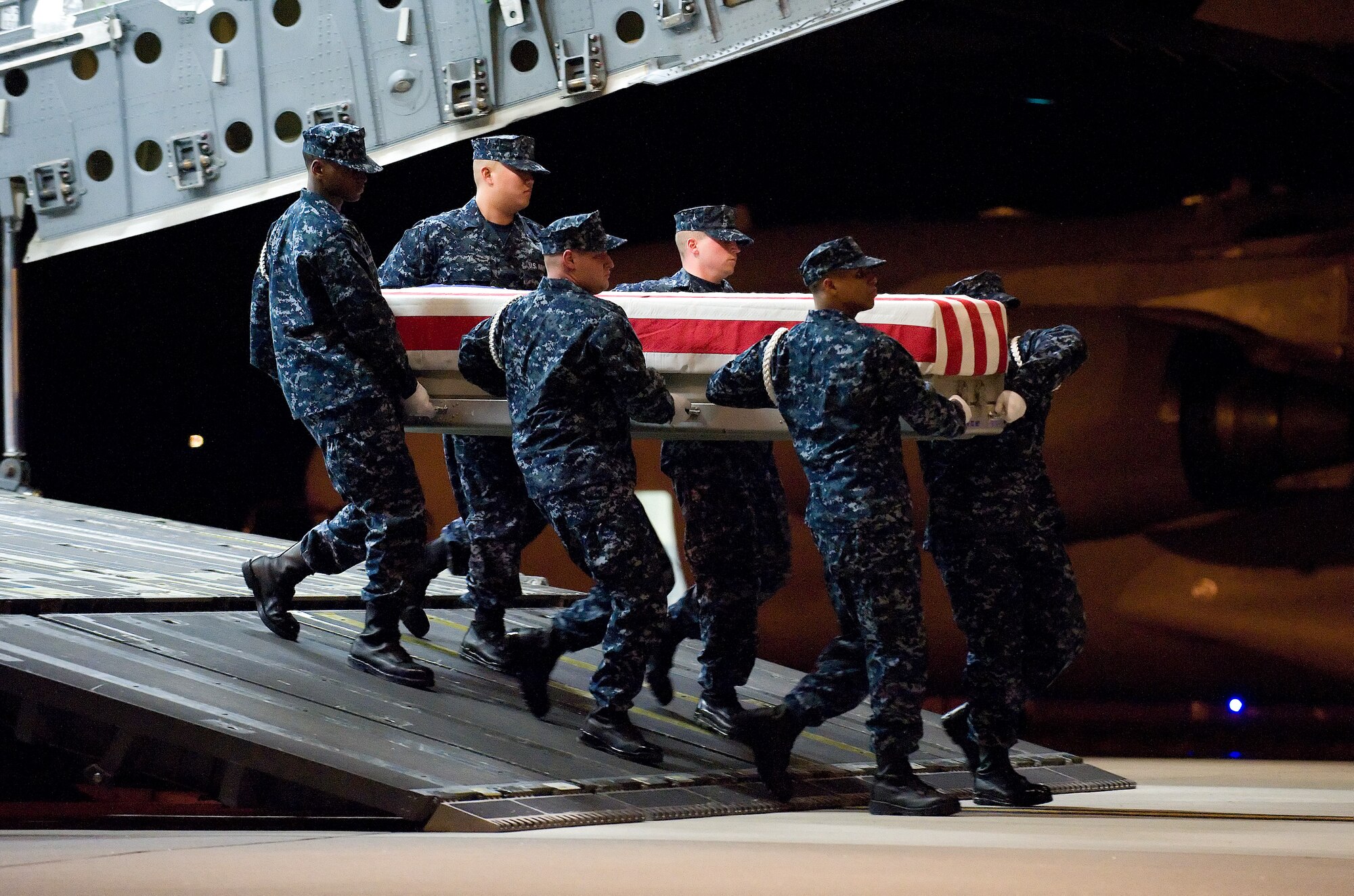 A U.S. Navy carry team transfers the remains of Navy Chief Petty Officer Adam L. Brown, of Hot Springs, Ark., at Dover Air Force Base, Del., March 19. (U.S. Air Force photo/Jason Minto)