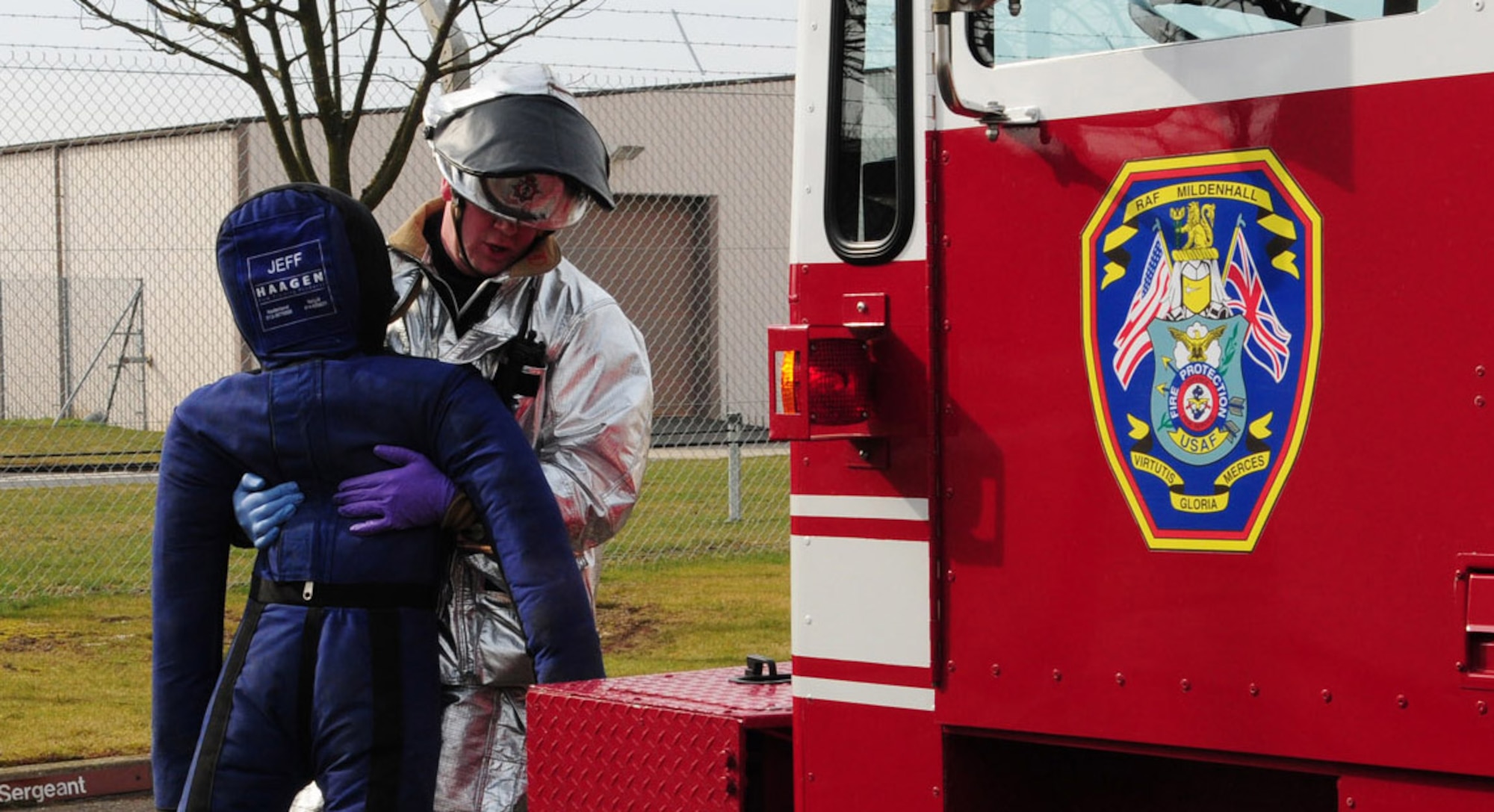 Lead Firefighter Simon Evans, 100th Civil Engineer Squadron Fire Department, takes a simulated casualty to a safe area during a training exercise March 18. A building was filled with smoke and firefighters had to go inside, search for possible casualties, and make sure the building was safe. (U.S. Air Force photo/Karen Abeyasekere)