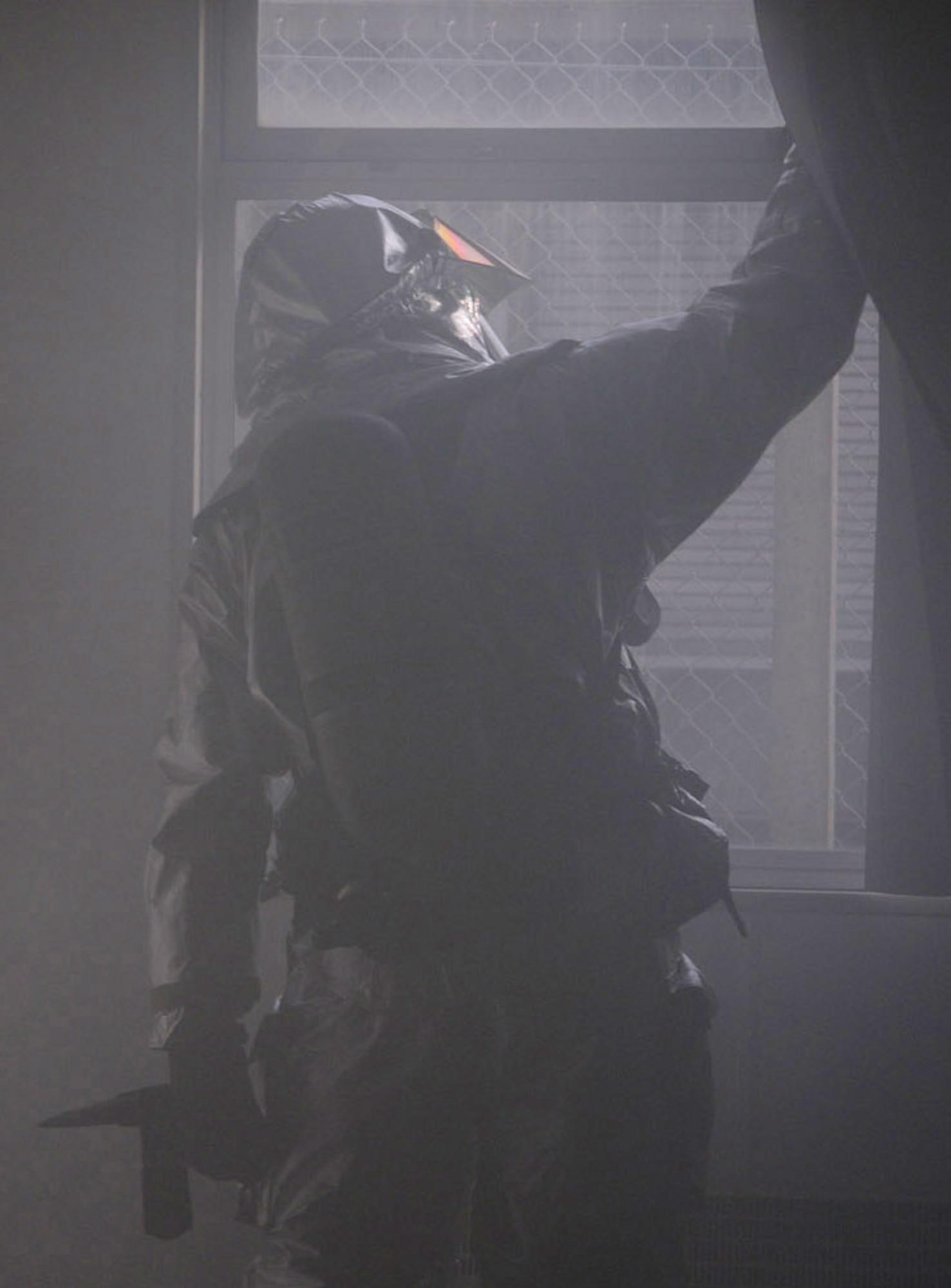Firefighter Matthew Leutkemeyer, 100th Civil Engineer Squadron Fire Department, closes a window following a training exercise March 18. Building 804 was filled with smoke and firefighters had to enter the facility and check for casualties using a thermal imaging camera. Two simulated casualties were located and rescued, and the building was thoroughly checked before the exercise was terminated. (U.S. Air Force photo/Karen Abeyasekere)