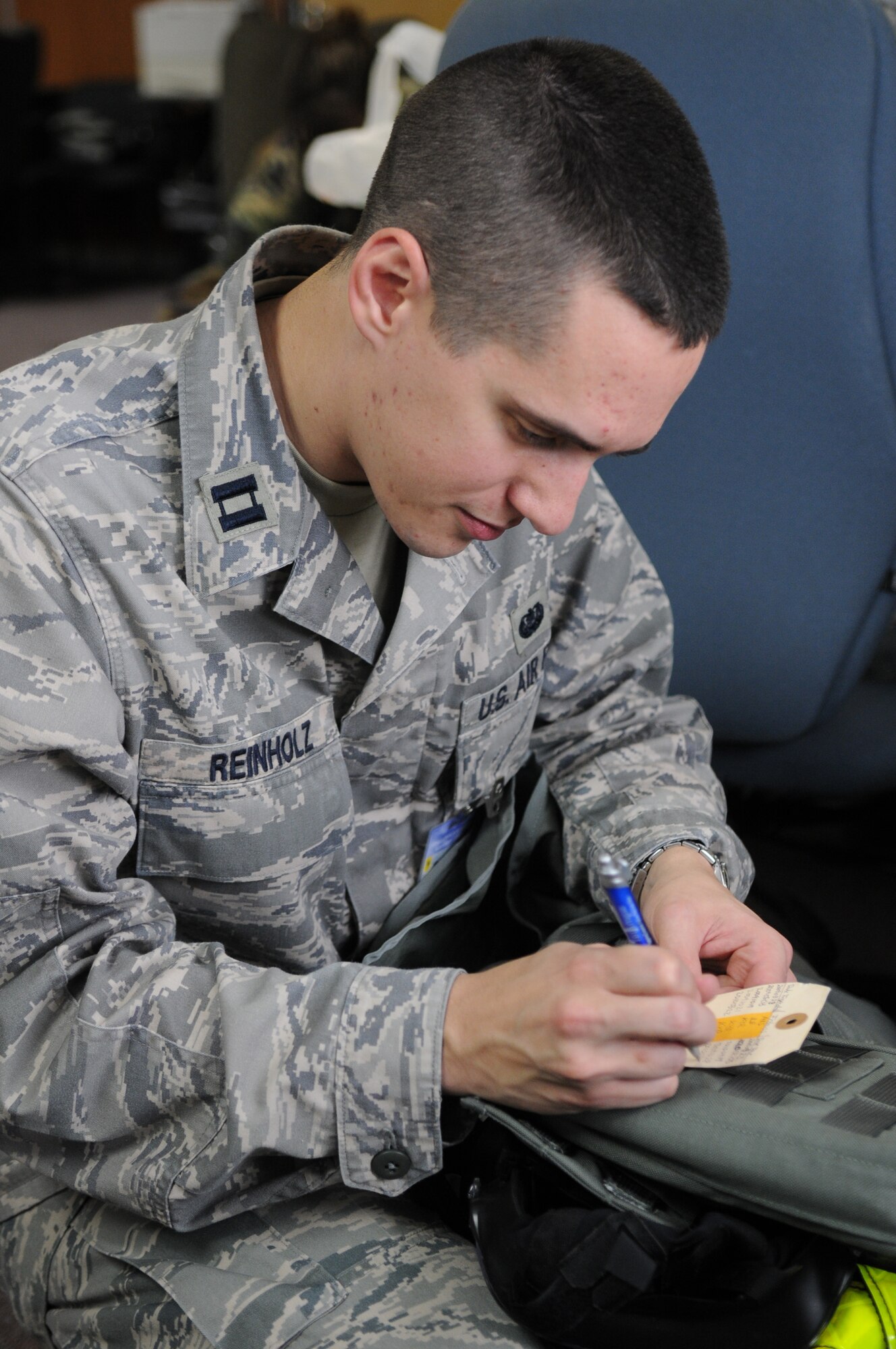 Captain Kevin Reinholz, 18th Judge Advocate office, inspects his gas mask for operational effectiveness during Day 1 of Beverly High 10-02 at Kadena Air Base, Japan, March 22. The 18th Wing is participating in a Local Operational Readiness Exercise March 22-26 to test the readiness of Kadena Airmen. (U.S. Air Force photo/Staff Sgt. Christopher Hummel)