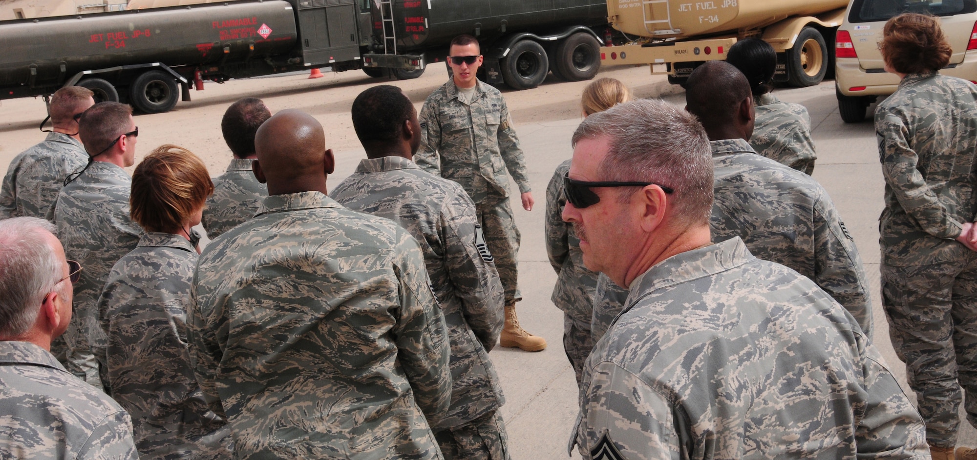 SOUTHWEST ASIA --  U.S. Air Force Airman 1st Class Colin Orr, 386th Expeditionary Logistics Readiness Squadron fuels distribution operator explains the in and outs of the base fuel trucks during an Open House March 21, 2010 hosted by the Fuels Management Flight here at an air base in Southwest Asia. In a given day, fuels distribution operators conduct between 40-50 refueling runs. During the open house, members of the 386th Air Expeditionary Wing ventured down to the flight line side of the base, known as “The Quarry”, to learn about the fuels process from start to finish. (U.S. Air Force photo by Staff Sgt. Lakisha A. Croley/Released)