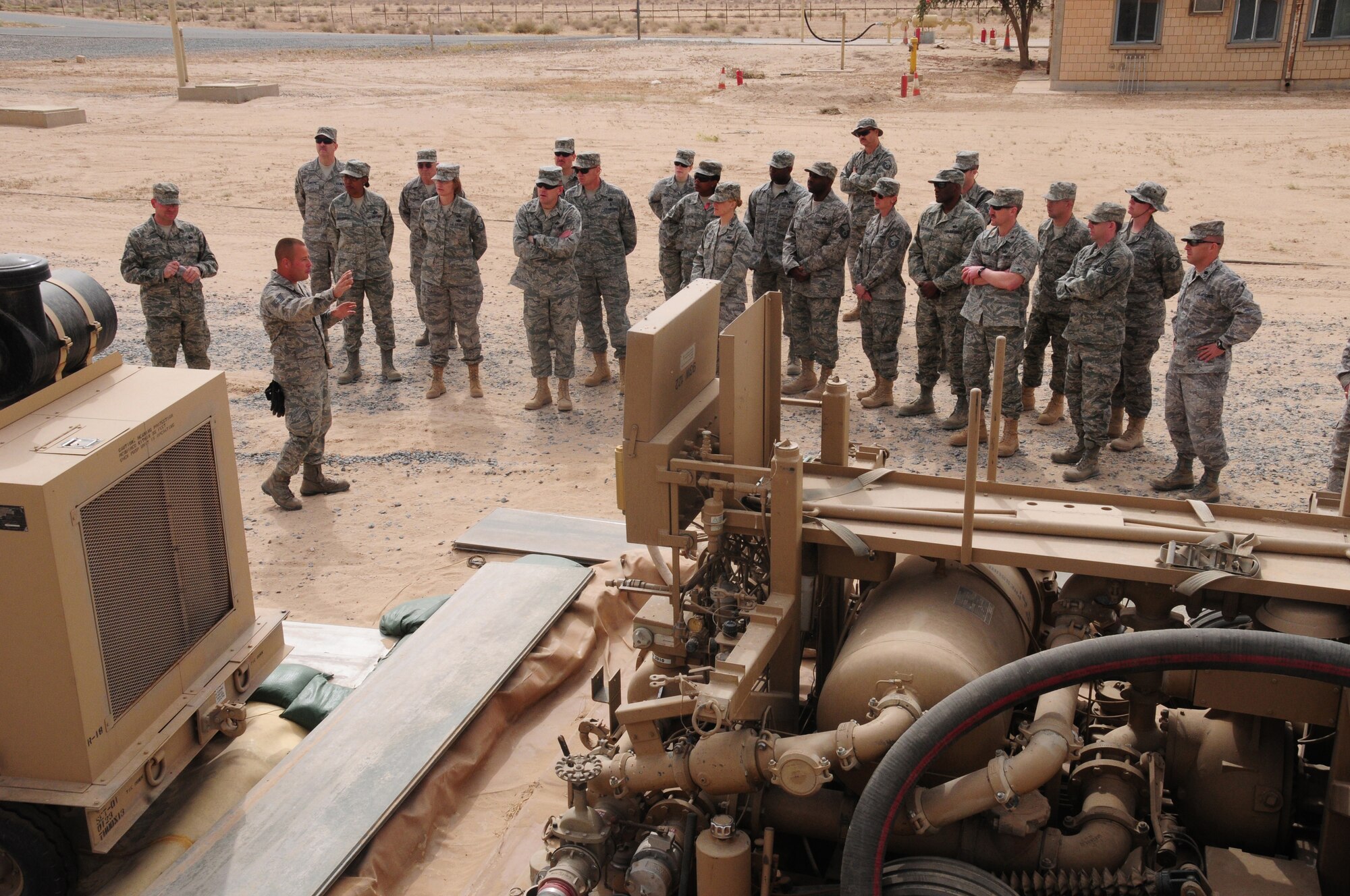 SOUTHWEST ASIA --  U.S. Air Force Tech. Sgt. Rick Rojas, 386th Logistics Readiness Squadron NCO in charge of fuels storage explains how fuel is offloaded from the trucks and transferred into the 200,000-gallon bladders during an Open House March 21, 2010 hosted by the Fuels Management Flight here at an air base in Southwest Asia.  During the open house, members of the 386th Air Expeditionary Wing ventured down to the flight line side of the base, known as “The Quarry”, to learn about the fuels process from start to finish.  (U.S. Air Force photo by Staff Sgt. Lakisha A. Croley/Released)