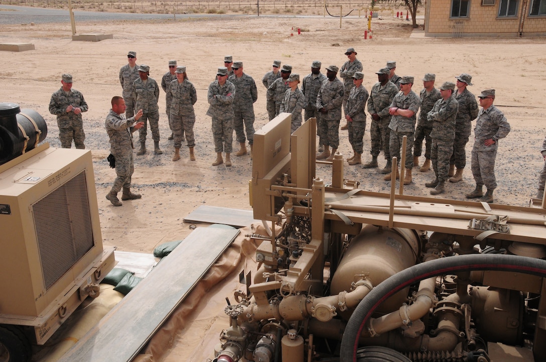 SOUTHWEST ASIA --  U.S. Air Force Tech. Sgt. Rick Rojas, 386th Logistics Readiness Squadron NCO in charge of fuels storage explains how fuel is offloaded from the trucks and transferred into the 200,000-gallon bladders during an Open House March 21, 2010 hosted by the Fuels Management Flight here at an air base in Southwest Asia.  During the open house, members of the 386th Air Expeditionary Wing ventured down to the flight line side of the base, known as “The Quarry”, to learn about the fuels process from start to finish.  (U.S. Air Force photo by Staff Sgt. Lakisha A. Croley/Released)