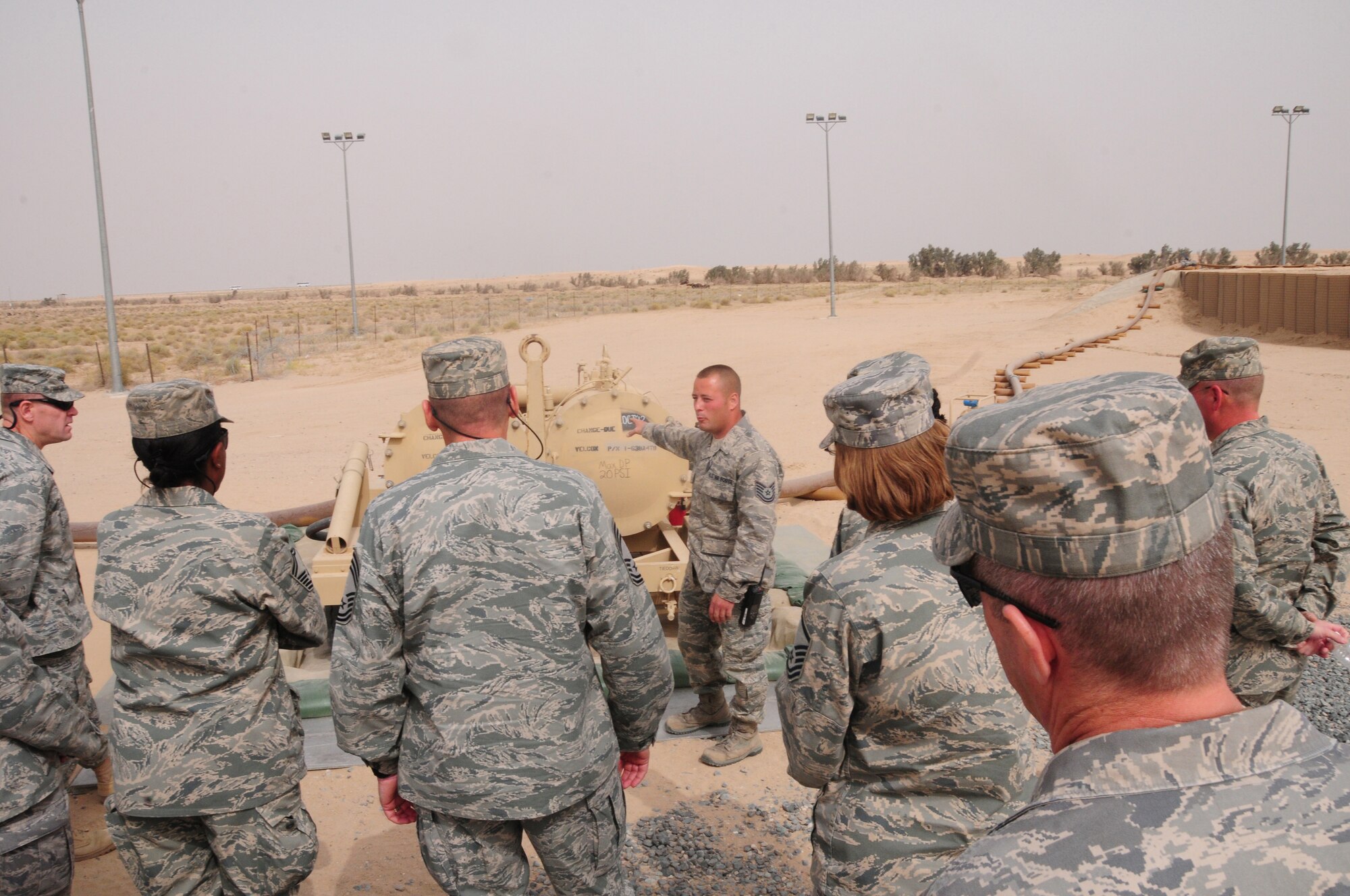 SOUTHWEST ASIA --  U.S. Air Force Tech. Sgt. Rick Rojas, 386th Logistics Readiness Squadron NCO in charge of fuels storage explains how fuel is offloaded from the trucks and transferred into the 200,000-gallon bladders during an Open House March 21, 2010 hosted by the Fuels Management Flight here at an air base in Southwest Asia.  During the open house, members of the 386th Air Expeditionary Wing ventured down to the flight line side of the base, known as “The Quarry”, to learn about the fuels process from start to finish.  (U.S. Air Force photo by Staff Sgt. Lakisha A. Croley/Released)