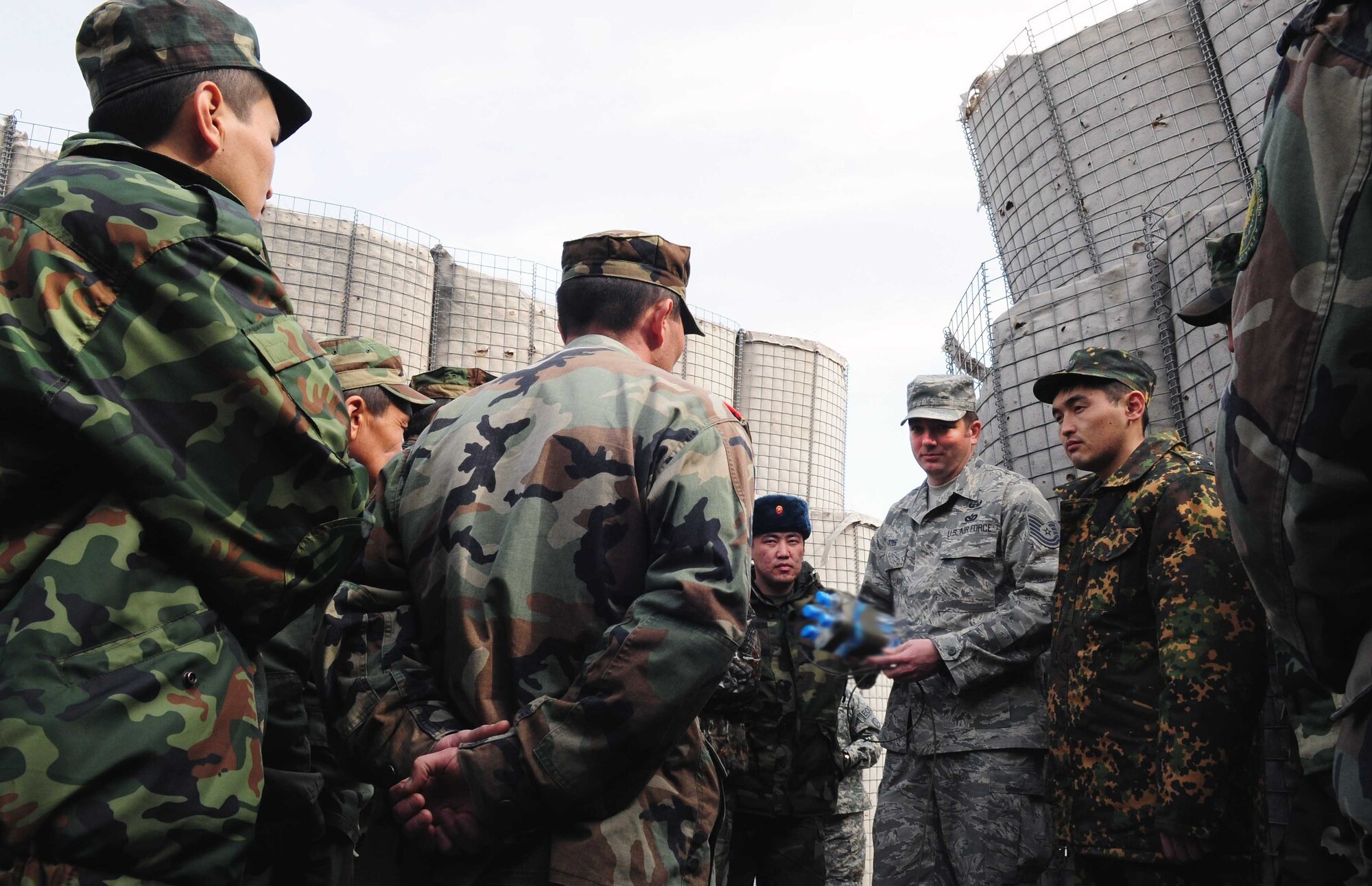 U.S. Air Force Tech. Sgt. Michael Yates, 376th Expeditionary Civil Engineer Squadron explosive ordnance disposal flight chief, discusses improvised water charges with Kyrgyz army EOD techs during a subject matter information exchange March 17. (U.S. Air Force photo/Staff Sgt. Carolyn Viss/released) 
