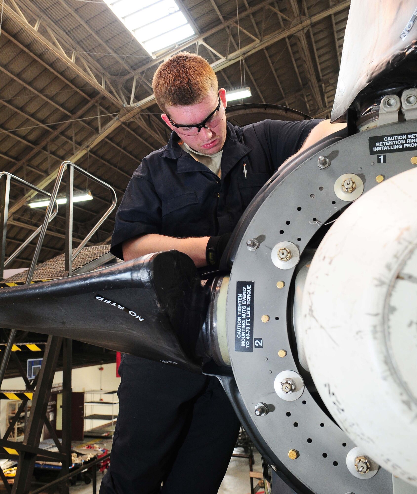 YOKOTA AIR BASE, Japan -- Airman 1st Class Garrick Kanen, 374th Maintenance Squadron, replaces a brush block on the engine of a MC-130 talon II March 16 during inspection. Each plane undergoes an isochronal inspection which consists of a 14-day detailed inspection before the plane is ready for re-launch. (U.S. Air Force photo/Airman 1st Class Devin Doskey)