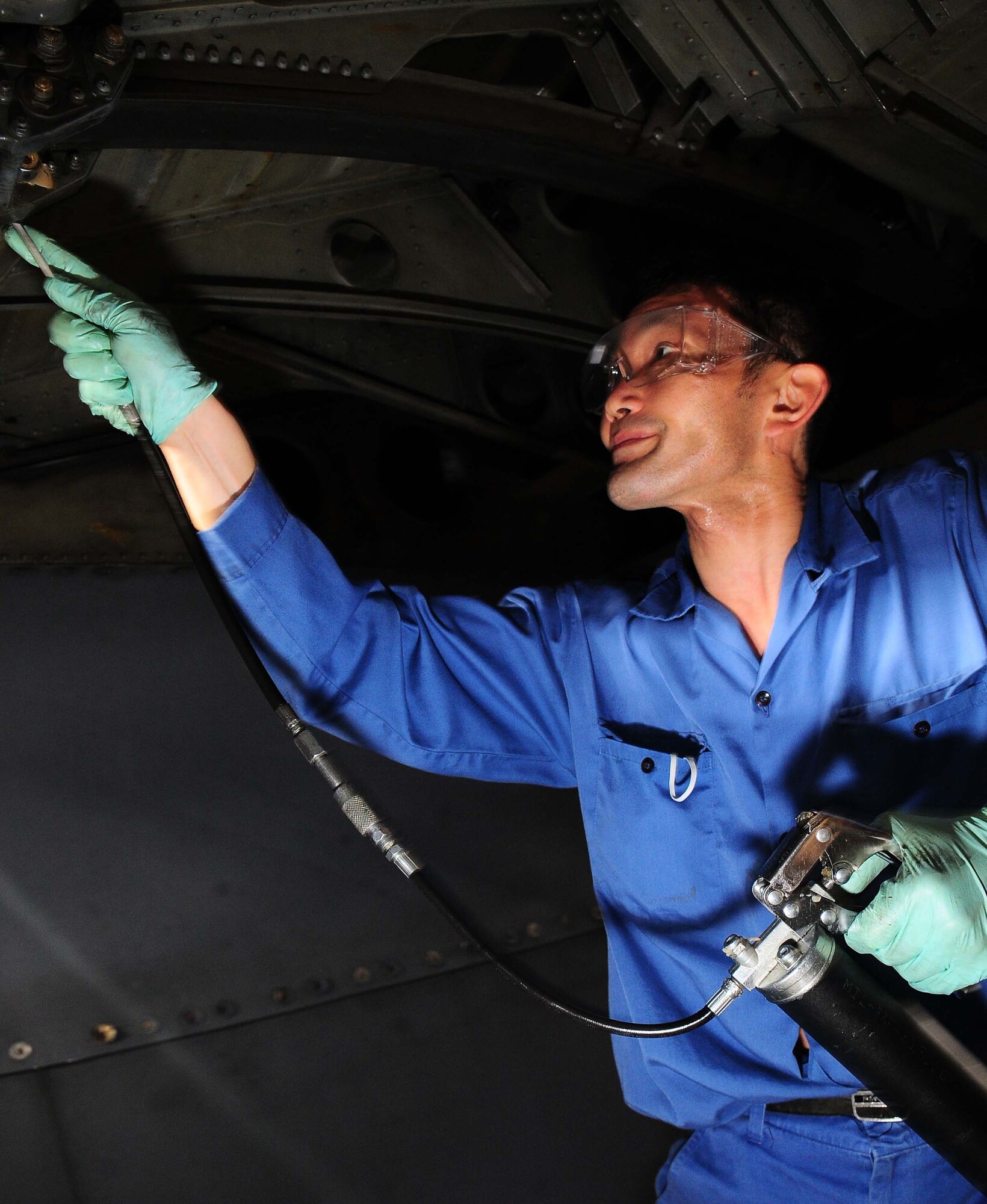 YOKOTA AIR BASE, Japan -- Toshio Shimida, 374th Maintenance Squadron, lubes a flap track on a MC-130 talon II March 16 during inspection. Each plane undergoes an isochronal inspection which consists of a 14-day detailed inspection before the plane is ready for re-launch. (U.S. Air Force photo/Airman 1st Class Devin Doskey)
