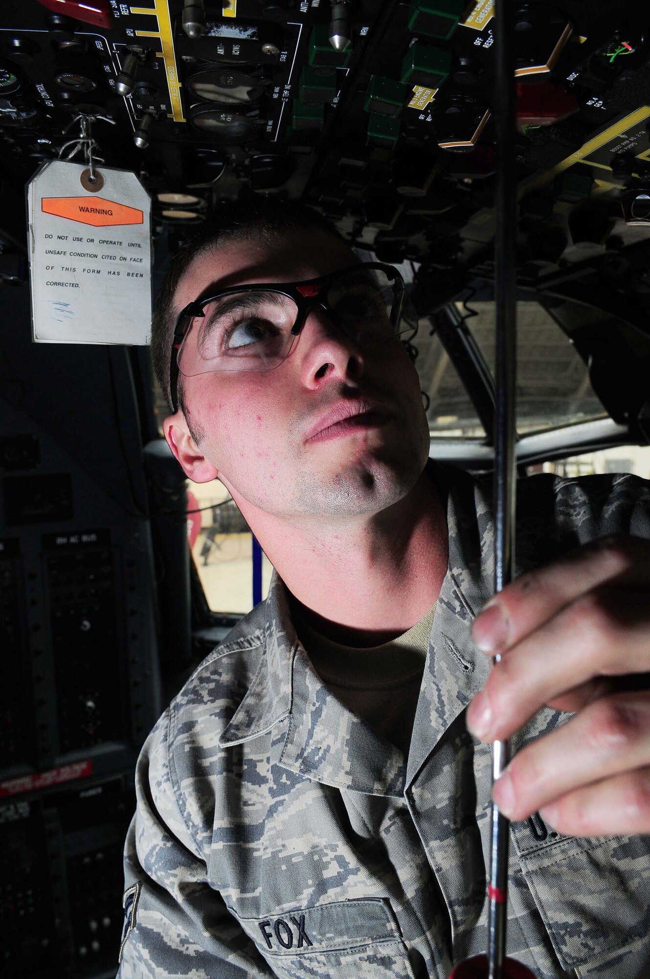 YOKOTA AIR BASE, Japan -- Airman 1st Class Branden Fox, 374th Maintenance Squadron crew chief, lowers an overhead instrument panel in the cockpit of a MC-130 talon II March 16 during inspection. Each plane undergoes an isochronal inspection which consists of a 14-day detailed inspection before the plane is ready for re-launch. (U.S. Air Force photo/Airman 1st Class Devin Doskey)