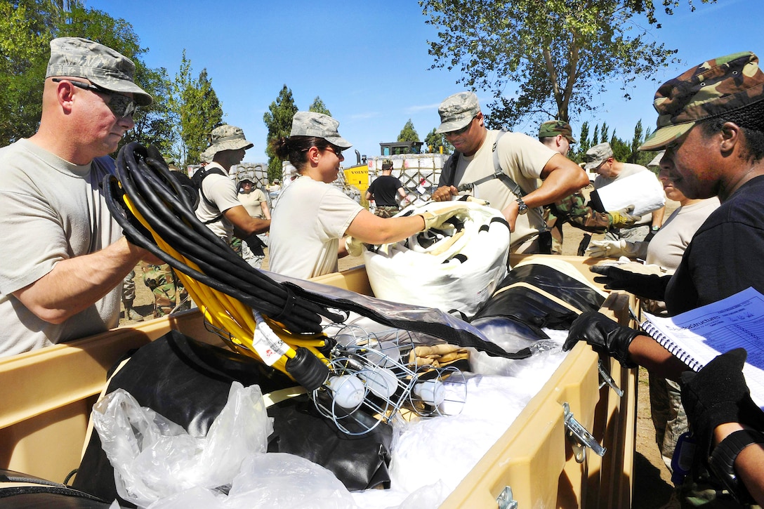 U.S. Air Force airmen unload supplies for a mobile hospital in Angol, Chile, March 10, 2010. The airmen, assigned to an Air Force Expeditionary Medical Support team, and members of the Chilean army built the hospital to help augment medical services for nearly 110,000 Chileans in the region. The emergency team is equipped and staffed to provide surgical, primary care, pediatric, radiological, gynecological, laboratory, pharmaceutical and dental services.