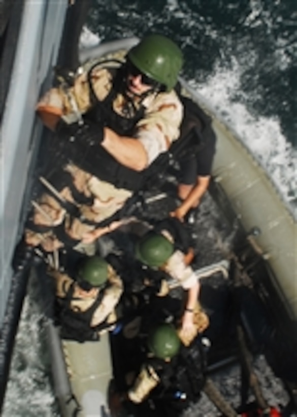 U.S. Navy Lt. j.g. Jonathan Greenwald, the boarding officer aboard the forward-deployed amphibious dock landing ship USS Harpers Ferry (LSD 49), climbs from a rigid-hulled inflatable boat onto the Philippine navy auxiliary ship BPR Dagupan City (LC 551) during a joint, board, search and seizure exercise in the Philippines on March 13, 2010.  