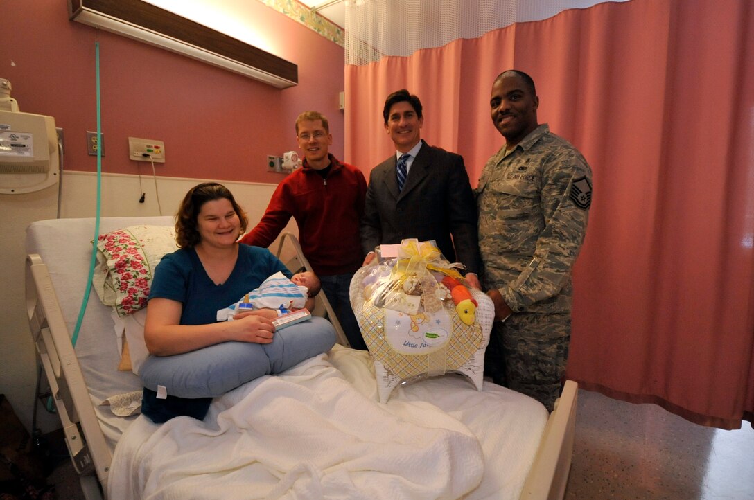 Master Sgt. Ryan Dolan of The AF Band’s Singing Sergeants and his wife, Amy Dolan celebrate the birth of their daughter Elizabeth Feb. 3, 2010. Standing to their right is Michael Chiaramonte, CEO of Southern Maryland Hospital Center and Master Sgt. Bobby Harris, who served as the 779th Medical Support Squadron’s liaison to SMHC. Baby Dolan was the first child delivered as part of a new an agreement between the 779th MSS, which runs Malcolm Grow Medical Center, and SMHC. Inpatient services previously offered at MGMC, such as child delivery, will be totally serviced by SMHC beginning September, 2011.