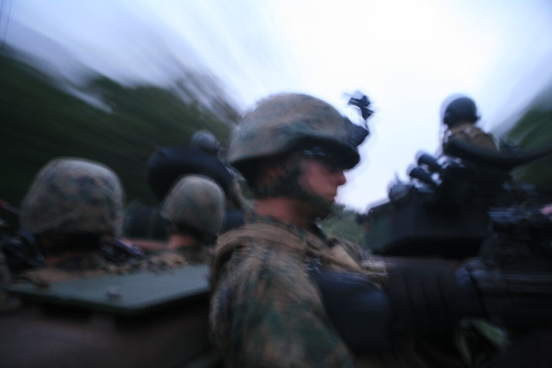 Marines with Battalion Landing Team 2nd Battalion, 7th Marines (BLT 2/7), 31st Marine Expeditionary Unit (MEU), provide security while the amphibious assault vehicle rushes to its objective during a simulated mechanized raid, March 23. The MEU conducted a tactical offload consisting of a mechanized raid, boat raid, helicopter raid and a humanitarian assistance and disaster relief (HA/DR) exercise. This is the first time that the MEU conducted  a tactical offload in Okinawa, Japan. (Official Marine Corps photo by Lance Cpl. Dengrier M. Baez)