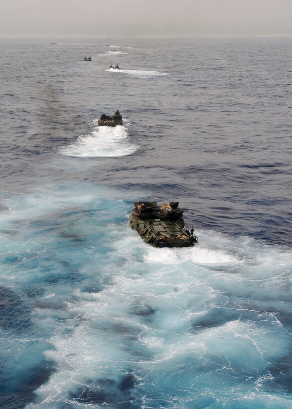 Amphibious assault vehicles assigned to the 31st Marine Expeditionary Unit (MEU) debark the well deck of the forward-deployed amphibious assault ship USS Essex (LHD 2). The 31st MEU and Essex Amphibious Ready Group recently returned from its annual spring patrol of the Asia Pacific region.