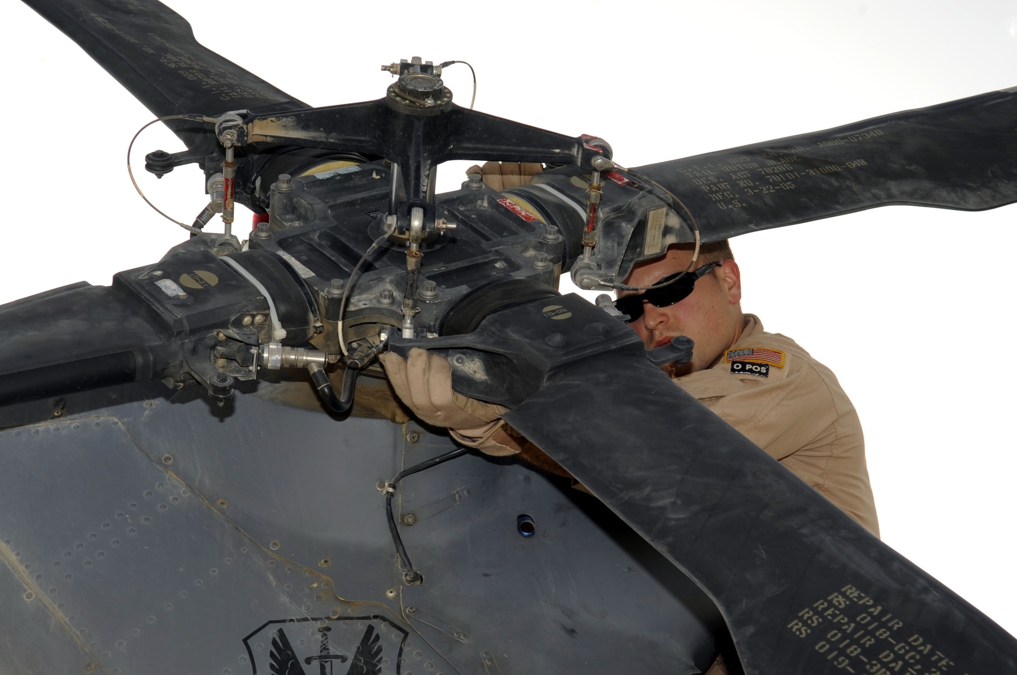 Tech. Sgt. William Nabakowski, 66th Expeditionary Rescue Squadron aerial gunner, conducts a routine preflight check on a HH-60G Pave Hawk helicopter March 5.  Sergeant Nabakowski is assigned to the 66th Rescue Squadron from Nellis AFB, NV.  (U.S. Air Force photo by Senior Airman Nancy Hooks/Released)