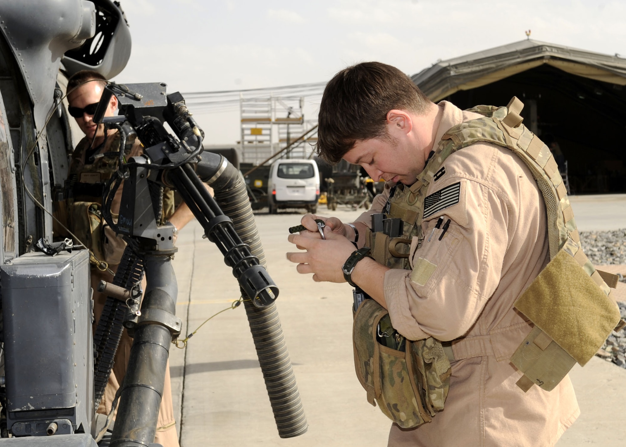Capt. Rob Roth, 66th Expeditionary Rescue Squadron mission pilot, gears up during a preflight check March 5.  Captain Roth is assigned to the 66th Rescue Squadron from Nellis AFB, NV. The HH-60G Pave Hawk helicopter is postured to take-off at a moment's notice in response to medical evacuation requests.  (U.S. Air Force photo by Senior Airman Nancy Hooks/Released)