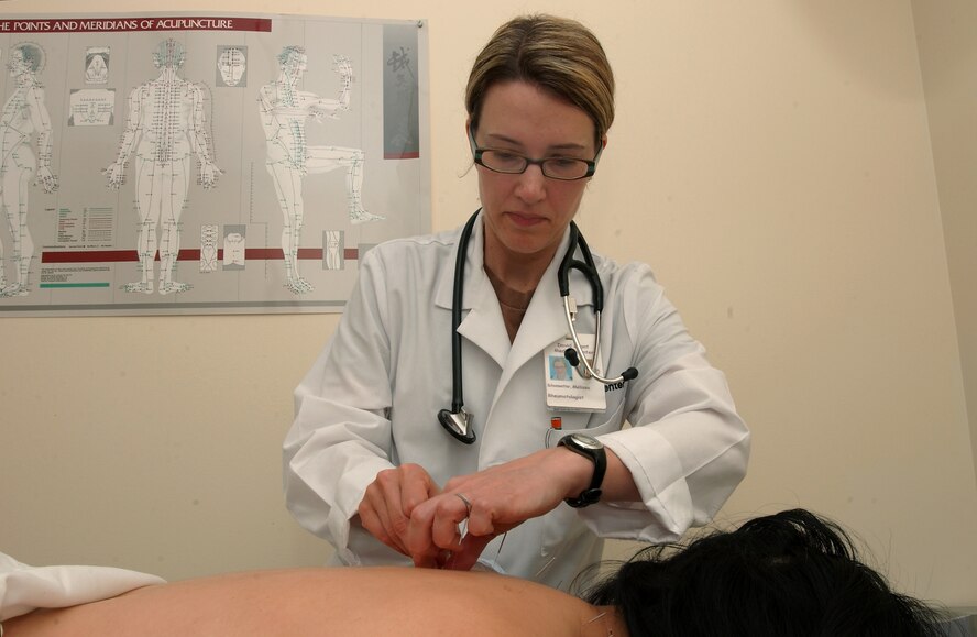An Acupunturist applies the age-old Chinese healing process on a patient at the David Grant USAF Medical Center. (U.S. Air Force photo / SrA Lilliana E Moreno-Miranda)