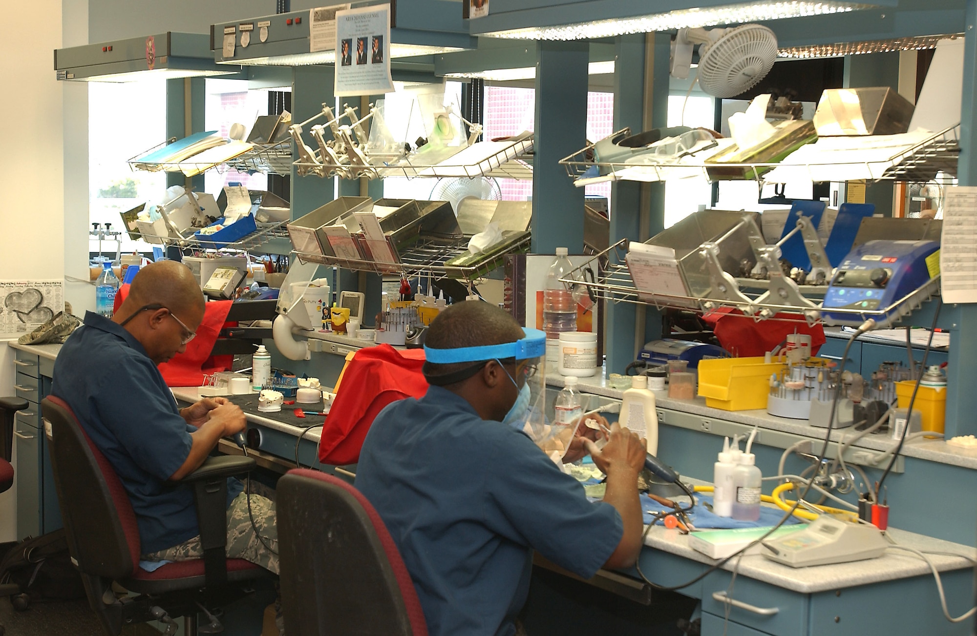 Dental technicians at the David Grant USAF Medical Center's Arthur J. Sachsel Dental Clinic work at crafting new dental implants for patients. (U.S. Air Force photo / SrA Lilliana E Moreno-Miranda)