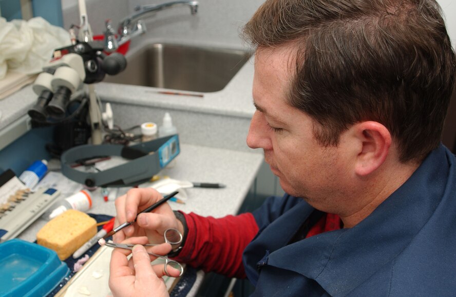 Dental technicians at the David Grant USAF Medical Center's Arthur J. Sachsel Dental Clinic work at crafting new dental implants for patients. (U.S. Air Force photo / SrA Lilliana E Moreno-Miranda)