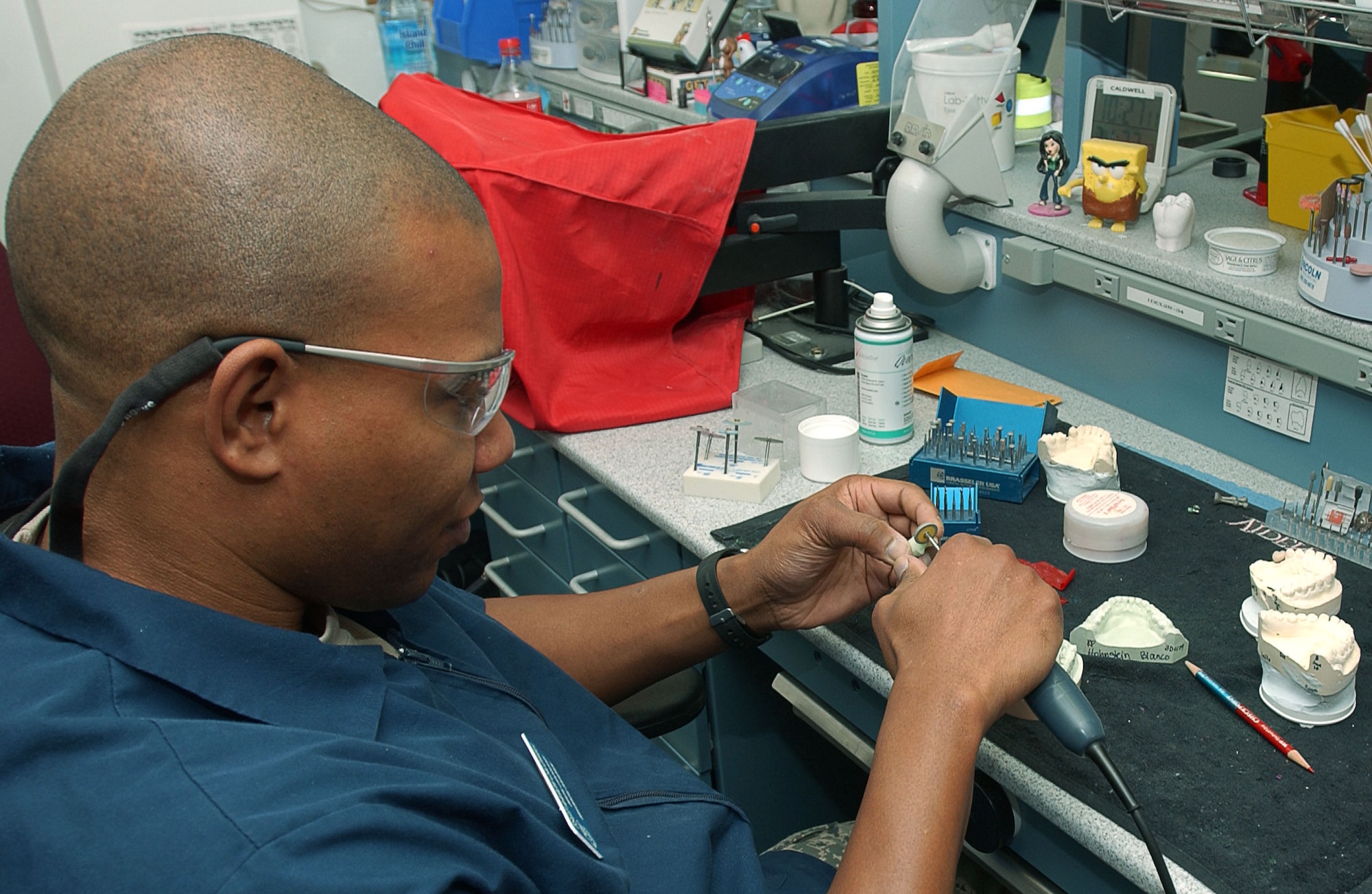 Dental technicians at the David Grant USAF Medical Center's Arthur J. Sachsel Dental Clinic work at crafting new dental implants for patients. (U.S. Air Force photo / SrA Lilliana E Moreno-Miranda)