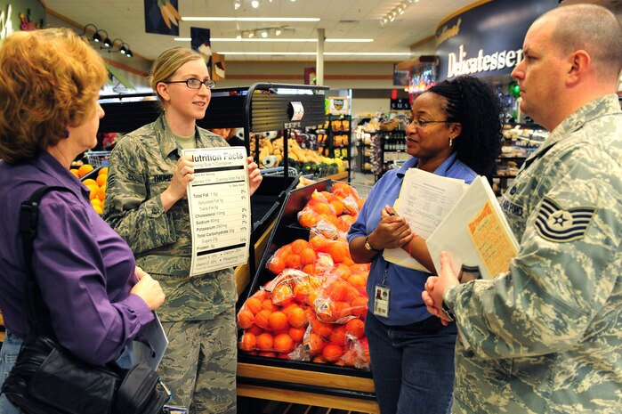 NELLIS AIR FORCE BASE, Nev. -- Senior Airman Crystal Thompson, 99th Medical Group diet therapy technician, takes Joyce Bethel, Tracie Atkins and TSgt Jarrod Kinner on a commissary tour to teach about healthy grocery shopping, March 12, 2010.  The commissary tour is  one of three events that the Nellis AFB nutrition department is hosting to promote National Nutrition Month during March.  (U.S. Air Force Photo by Staff Sgt. William P. Coleman/RELEASED)
