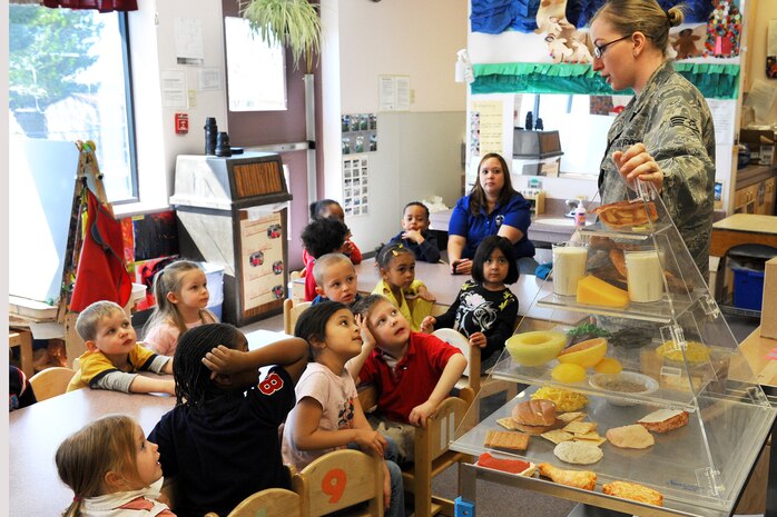 NELLIS AIR FORCE BASE, Nev. -- Senior Airman Crystal Thompson, 99th Medical Group diet therapy technician, teaches kids about healthy eating during a "Kids Nutrition Class" at the Child Development Center, March 12, 2010.  The "CDC Kids Nutrition" class is  one of three events that the Nellis AFB nutrition department is hosting to promote National Nutrition Month during March.  (U.S. Air Force Photo by Lawrence Crespo/RELEASED)