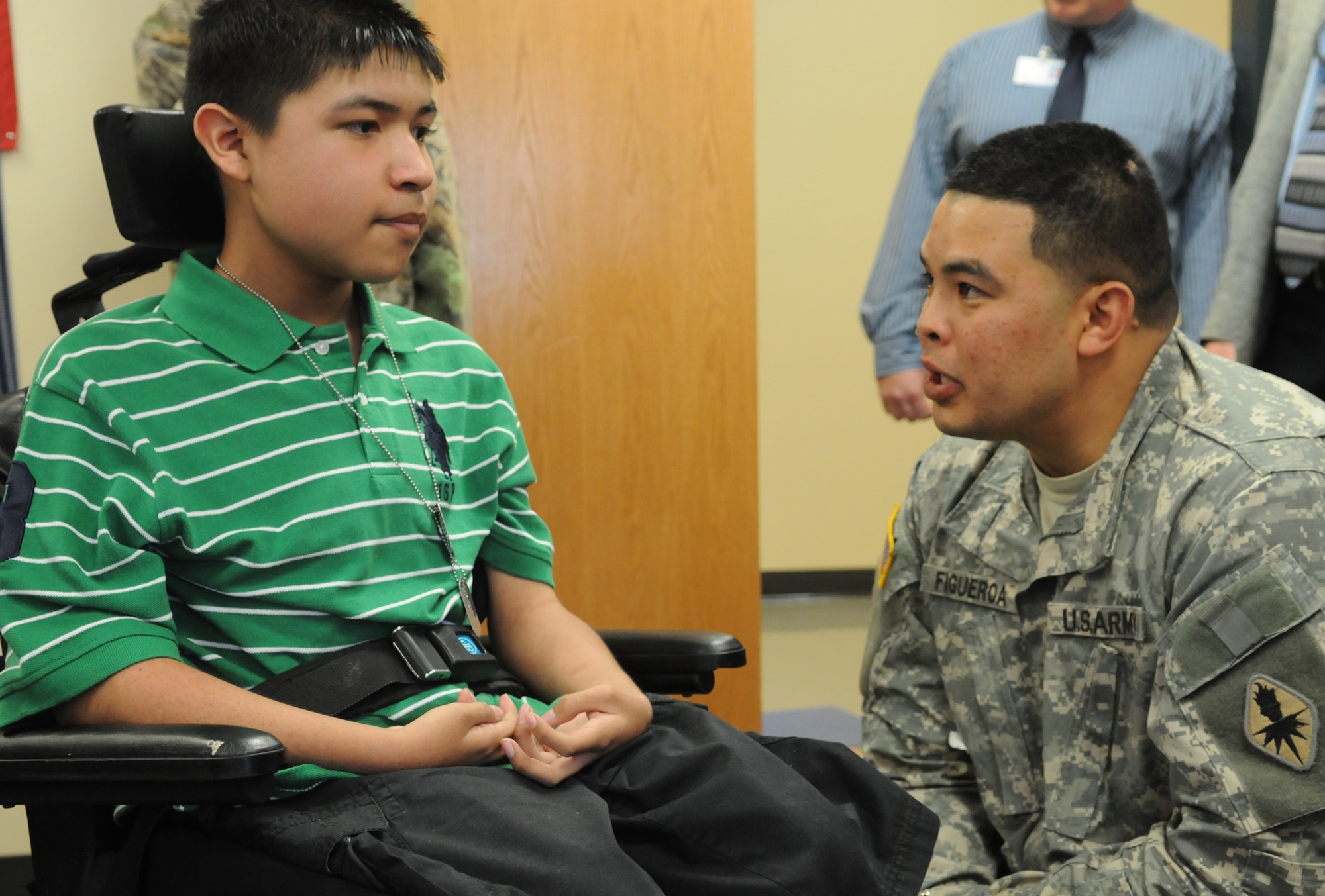 SAN ANGELO, Texas -- Army Sgt. 1st Class Samuel Figueroa speaks with Javier Aguirre at Lincoln Junior High School, March 23, 2010. Javier has Duchere Muscular Dystrophy and expressed a wish, through the Make-A-Wish Foundation, to meet with U.S. Army Soldiers. Sgt. 1st Class Figueroa and fellow Soldiers from the 344th Military Intelligence Battalion, Goodfellow Air Force Base, answered the call. (U.S. Air Force photo/Airman 1st Class Clayton Lenhardt)