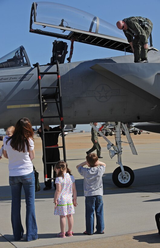 LANGLEY AIR FORCE BASE, Va. -- Maj. Brian Biebel, 71st Fighter Squadron pilot, checks his F-15C while his wife, Mandy, and children Connor, 5, Kaitlyn, 3, and Jack, 1, wait to greet him during his homecoming March 20. Ten F-15C Eagles from the 71st FS joined aircraft and personnel from five other bases to take part in a two week exercise called FANG Flag in Savannah, Ga. (U.S. Air Force photo/Airman Rebecca Montez)