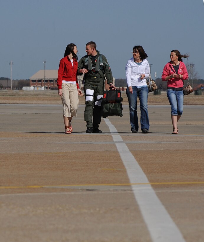 LANGLEY AIR FORCE BASE, Va. -- Capt. Glenn Meleen, 71st Fighter Squadron pilot, walks with his wife, Sarah, and her mother and sister, during his homecoming March 20. Ten F-15C Eagles from the 71st FS joined aircraft and personnel from five other bases to take part in a two week exercise called FANG Flag in Savannah, Ga. (U.S. Air Force photo/Airman Rebecca Montez)