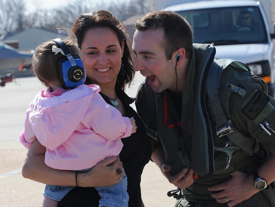 LANGLEY AIR FORCE BASE, Va. -- Capt. Michael Fritts, 71st Fighter Squadron pilot, greets his wife, Jiselle, and daughter Natalie, 11 months, during his homecoming March 20. Ten F-15C Eagles from the 71st FS joined aircraft and personnel from five other bases to take part in a two week exercise called FANG Flag in Savannah, Ga. (U.S. Air Force photo/Airman Rebecca Montez)