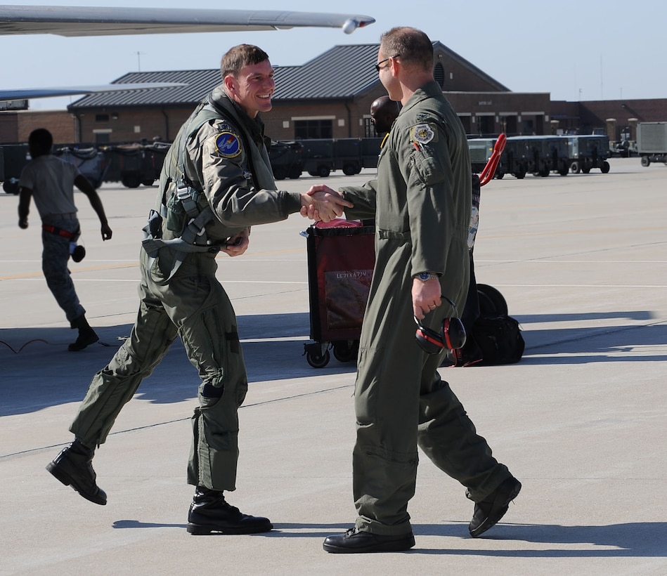LANGLEY AIR FORCE BASE, Va. -- Lt. Col. Joel Cook, 71st Fighter Squadron commander, greets Col. Dirk Smith, 1st Operations Group commander, during his homecoming March 20. Ten F-15C Eagles from the 71st FS joined aircraft and personnel from five other bases to take part in a two week exercise called FANG Flag in Savannah, Ga. (U.S. Air Force photo/Airman Rebecca Montez)