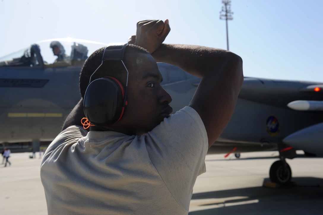 LANGLEY AIR FORCE BASE, Va. -- Airman 1st Class Floyd Semple, 71st Aircraft Maintenance Unit crew chief, brings Lt. Col. Joel Cook, 71st Fighter Squadron commander, to a stop March 20. Ten F-15C Eagles from the 71st Fighter Squadron joined aircraft and personnel from five other bases to take part in a two week exercise called FANG Flag in Savannah, Ga. (U.S. Air Force photo/Airman Rebecca Montez)