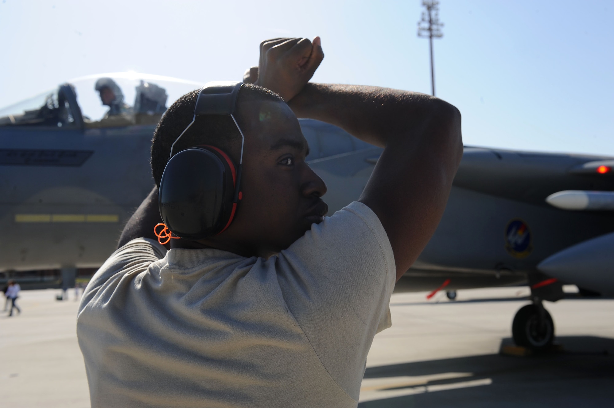 LANGLEY AIR FORCE BASE, Va. -- Airman 1st Class Floyd Semple, 71st Aircraft Maintenance Unit crew chief, brings Lt. Col. Joel Cook, 71st Fighter Squadron commander, to a stop March 20. Ten F-15C Eagles from the 71st Fighter Squadron joined aircraft and personnel from five other bases to take part in a two week exercise called FANG Flag in Savannah, Ga. (U.S. Air Force photo/Airman Rebecca Montez)