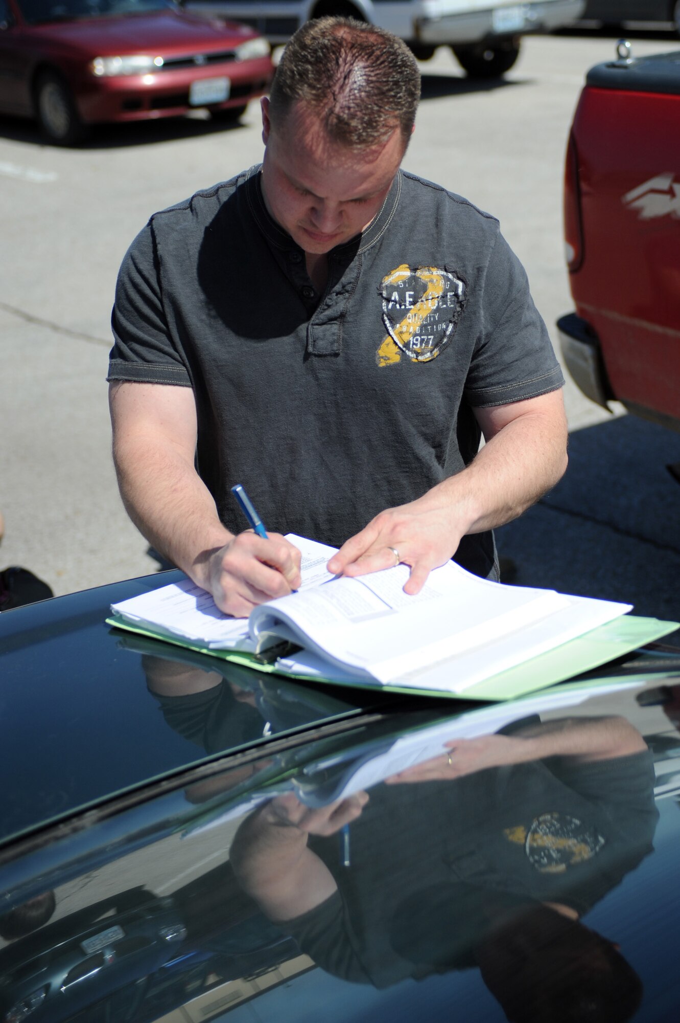 WHITEMAN AIR FORCE BASE, Mo., -- Staff Sgt. Ronal Reed, 509th Security Forces Squadron, fills out a child safety seat checklist before inspecting child seats in the car March 23, 2010. The one-on-one educational safety check usually takes 20 to 30 minutes, depending on the car seat and vehicle. (U.S. Air Force photo/Staff Sgt. Jason Huddleston)(Released)