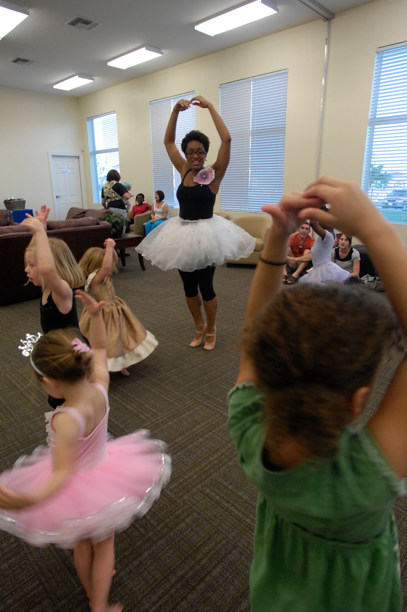 Toya Moore-Broyles, 56th Force Support Squadron base librarian, teaches the children attending the My Froggy Princess Dancing Play Group, March 16 at Luke Air Force Base, Ariz. Ms. Moore-Broyles offers the classes free of charge at 6 p.m., every Tuesday evening, minus the 1st Tuesday of the month, at the Balfour Beatty community center. (U.S. Air Force Photo by Staff Sgt. Jason Colbert)