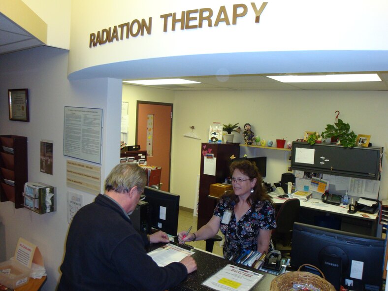 A patient checks in at the customer service counter for the Joint Radiation Oncology Center at David Grant USAF Medical Center. (U.S. Air Force photo / James Spellman, Jr.) 