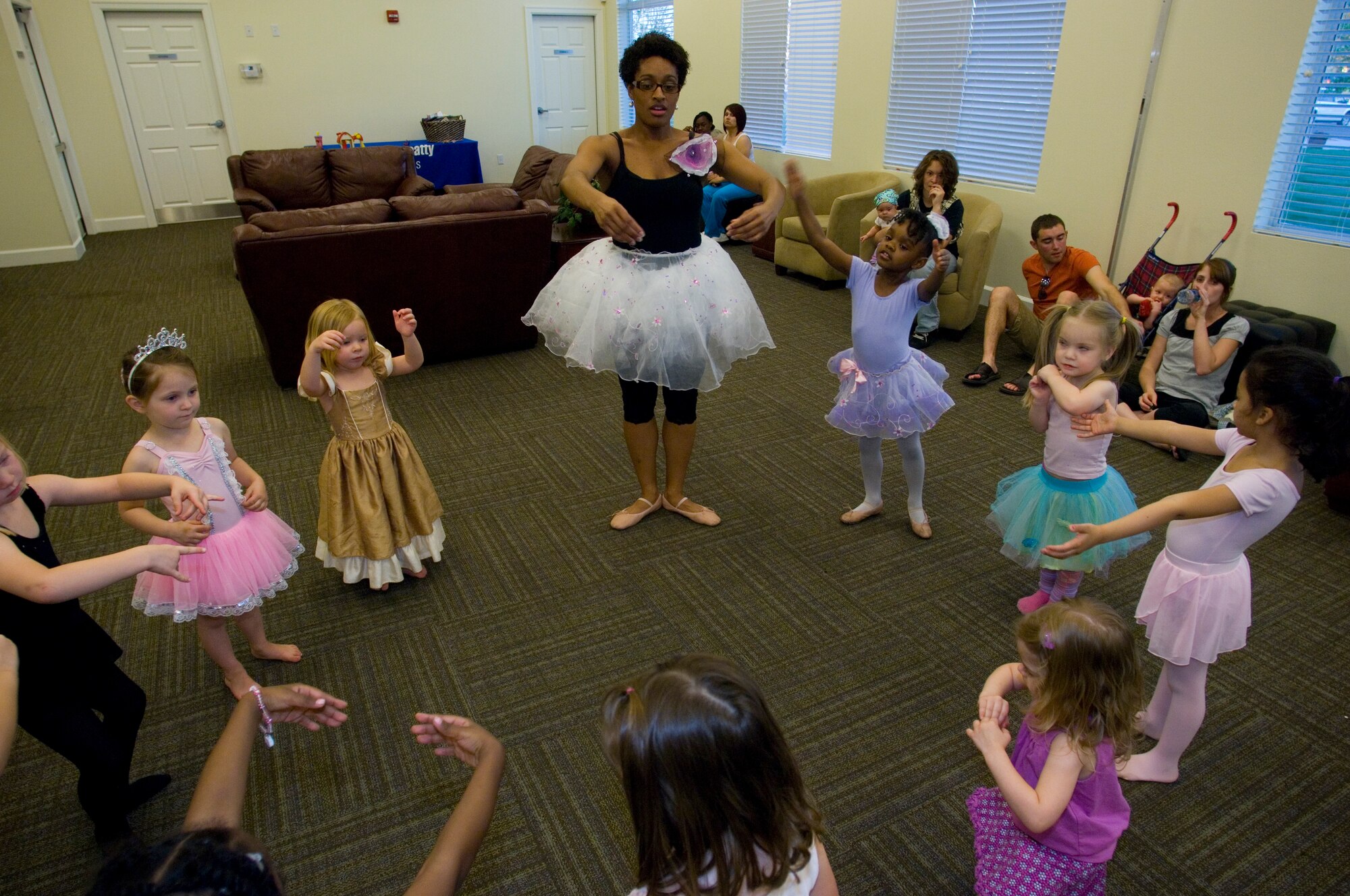 Toya Moore-Broyles, 56th Force Support Squadron base librarian, teaches the children attending the My Froggy Princess Dancing Play Group, March 16 at Luke Air Force Base, Ariz. "I  hold the classes as an alternative to children sitting in front of a TV," Moore-Broyles said. (U.S. Air Force Photo by Staff Sgt. Jason Colbert)
