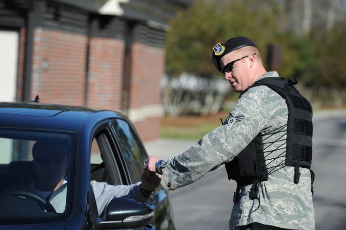 U.S. Air Force Senior Airman Daniel Keener completes an identification check at the Rivers Avenue gate on Joint Base Charleston, S.C., March 23, 2010. Airman Keener is a security forces patrolman with the 628th Security Forces Squadron. (U.S. Air Force photo/James Bowman/released)