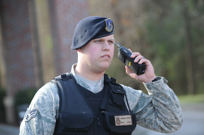 U.S. Air Force Senior Airman Joshua Handy redirects traffic at the Rivers Avenue gate at Joint Base Charleston, S.C., March 23, 2010. Airman Handy redirected traffic so maintenance work could be completed. Airman Handy is a security forces patrolman with the 628th Security Forces Squadron. (U.S. Air Force photo/James Bowman/released)