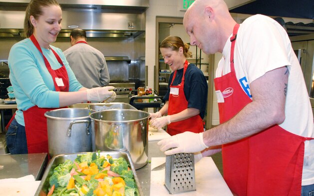 Capt. Gena Parkman and Master Sgts. Kim Mann and Dan Spain prepare meals at Marian House March 2, 2010. The three Airmen are part of the Air Force Academy's Unit Advisory Council. Captain Parkman is assigned to the Academy's Cadet Counseling Center. Sergeant Mann is superintendent of Cadet Wing Human Relations, and Sergeant Spain is superintendent of Basic Cadet Training. (U.S. Air Force photo/Ann Patton)