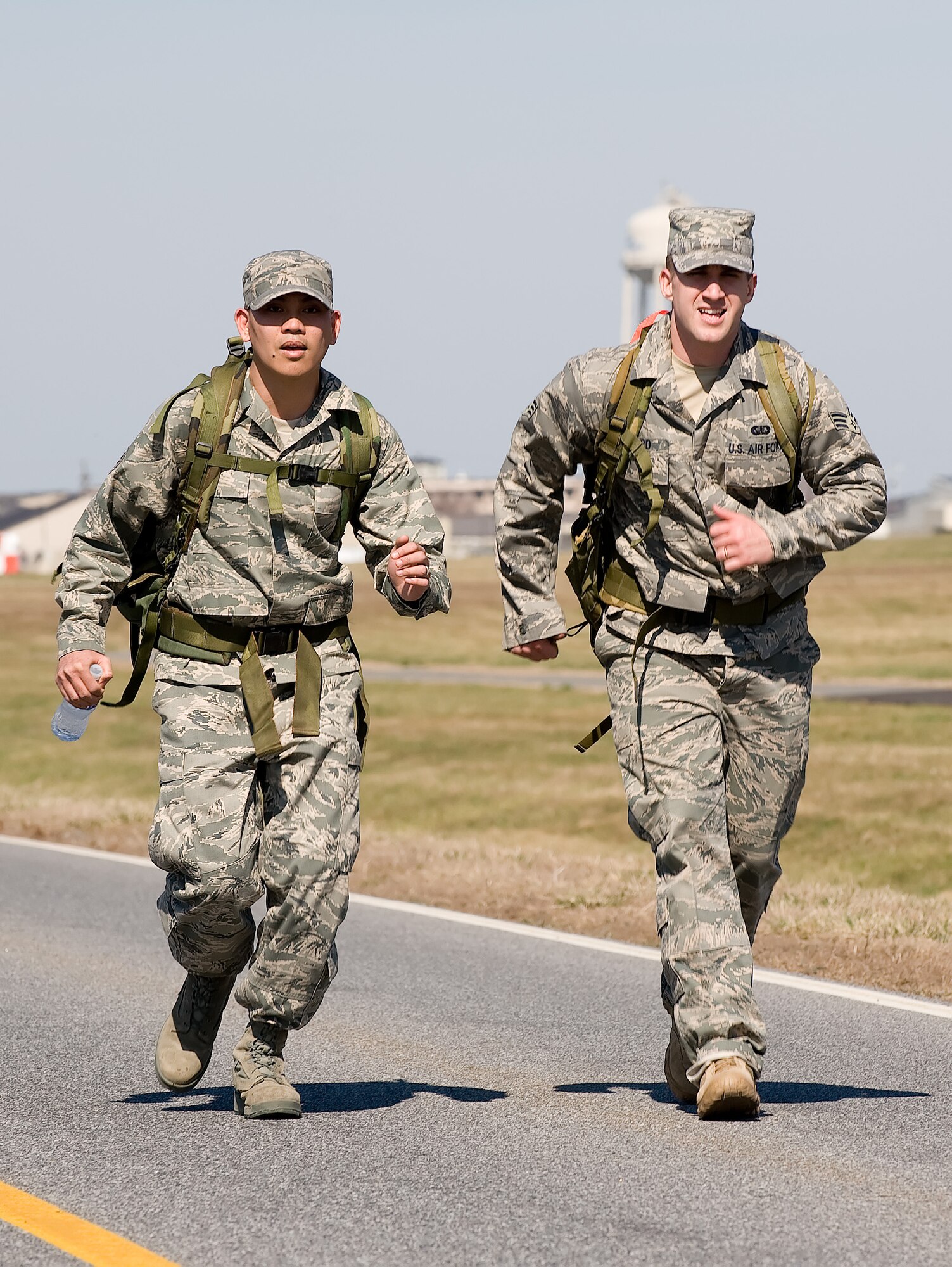 Staff Sgt. Herbert Dungca (left) and Senior Airman Jonathan Howard, Air Force Mortuary Affairs Operations Center Dignified Transfer team members, pick up the pace during the 436th Security Forces Squadron's 11th Annual Ruck March held March 20. The annual 6.2 mile march is a fundraiser to honor the veterans of the Korean War who fought in the Battle of the Chosin Reservoir. (U.S. Air Force photo/Jason Minto)