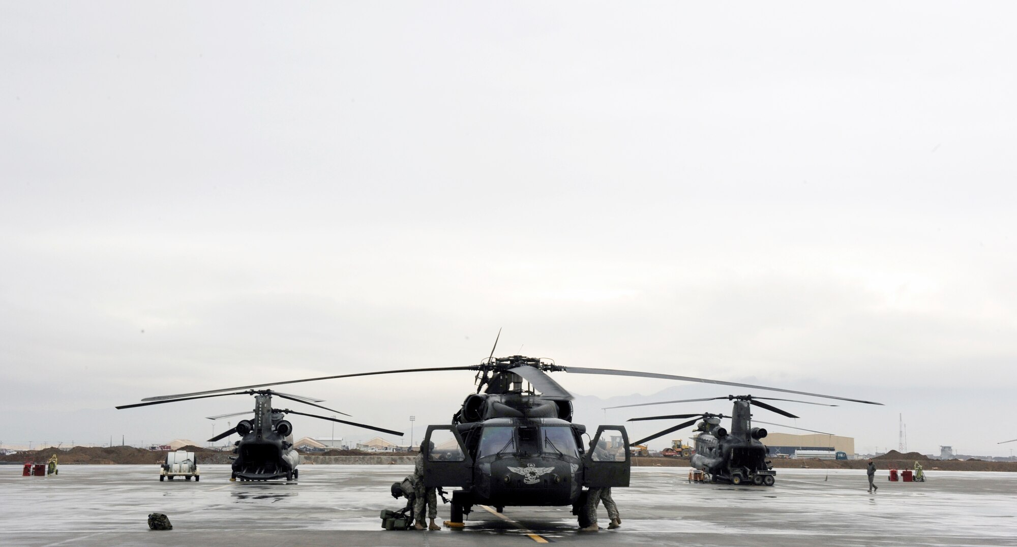 A UH-60 Blackhawk aircrew prepares a helicopter for a proficiency training flight for Afghanistan National Army Air Corp crew chief students to apply lessons taught to them by a team of Airmen from the 440th Air Expeditionary Advisory Squadron and Soldiers from the 3rd Combat Aviation Brigade, Task Force Falcon, Feb. 28, 2010, at Bagram Airfield, Afghanistan. (U.S. Air Force photo/Staff Sgt. Manuel J. Martinez)