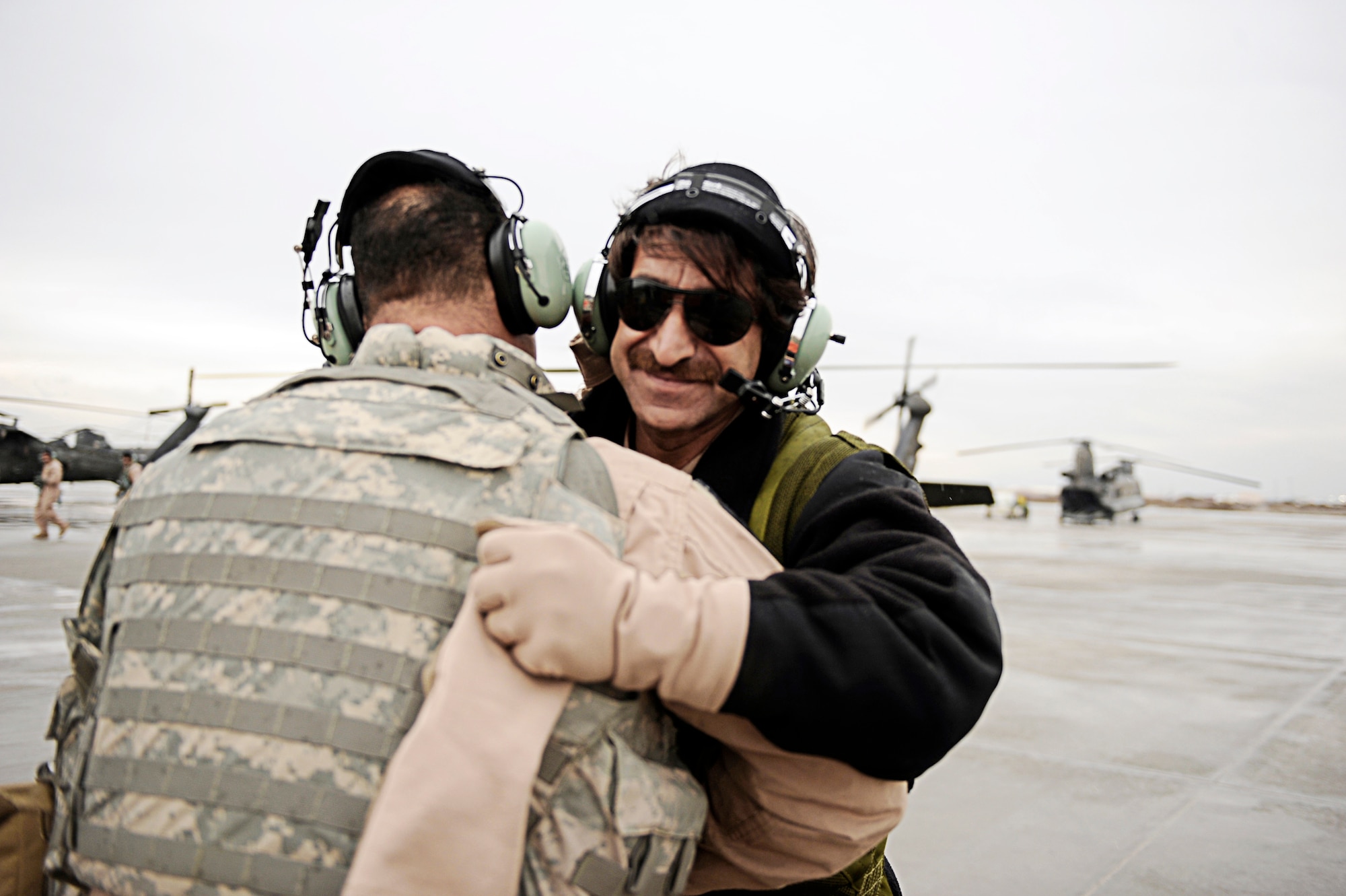 Afghan National Army Air Corps Sgt. Abdul Wali hugs one of his mentors, Tech. Sgt. Garrett Cain, after a UH-60 Blackhawk proficiency flight, Feb. 28, 2010, at Bagram Airfield, Afghanistan. Sergeant Wali is a crew chief and Sergeant Cain is a rotary-wing crew chief mentor assigned to 440th Air Expeditionary Advisory Squadron (U.S. Air Force photo/Staff Sgt. Manuel J. Martinez)
