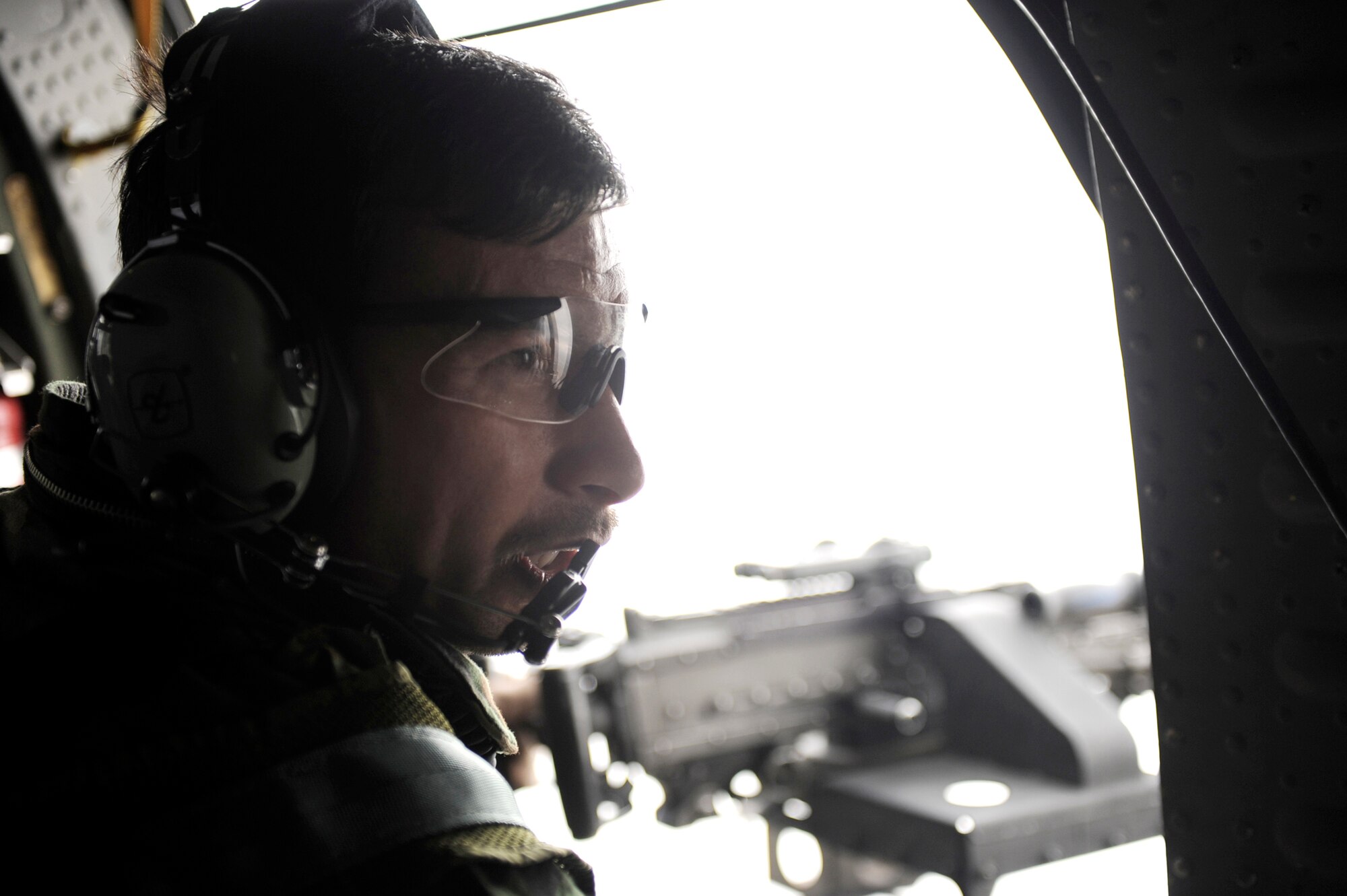 Afghan National Army Air Corps Sgt. M-Yousaf Wafa practices skills he learned at the Afghan National Security Forces Crew Chief Academy, during a flight on a UH-60 Blackhawk, Feb. 28, 2010, over Parwan Province, Afghanistan. Sergeant Wafa is a crew chief. (U.S. Air Force photo/Staff Sgt. Manuel J. Martinez)