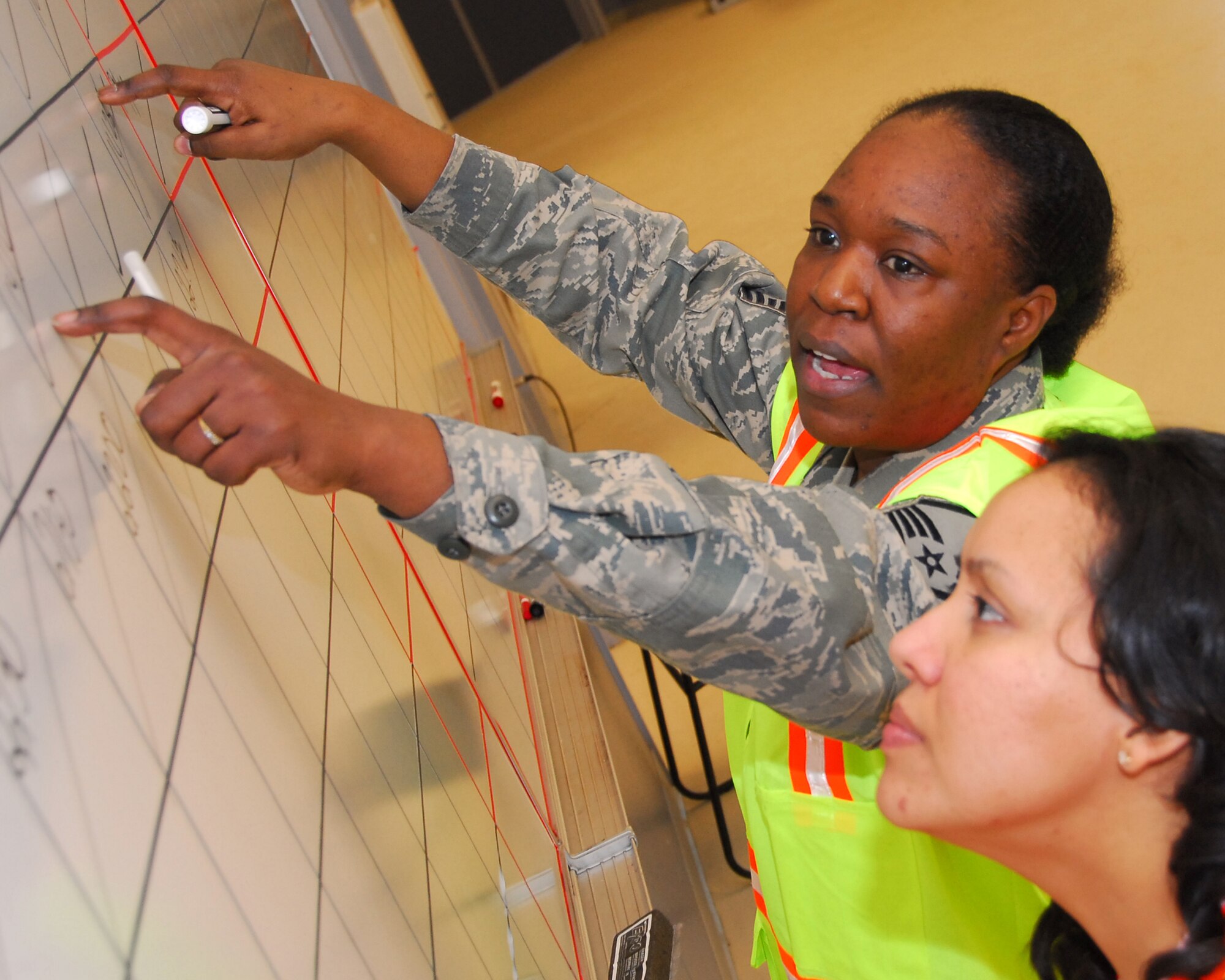 Master Sgt. Tara Withers looks over and logs chalk processing times during an Operational Readiness Exercise March 21, 2010, Eielson Air Force Base, Alaska. Sergeant Withers is the Career Development Superindendent 354th Force Support Squadron. (U.S. Air Force photo/Staff Sgt. James Stewart)