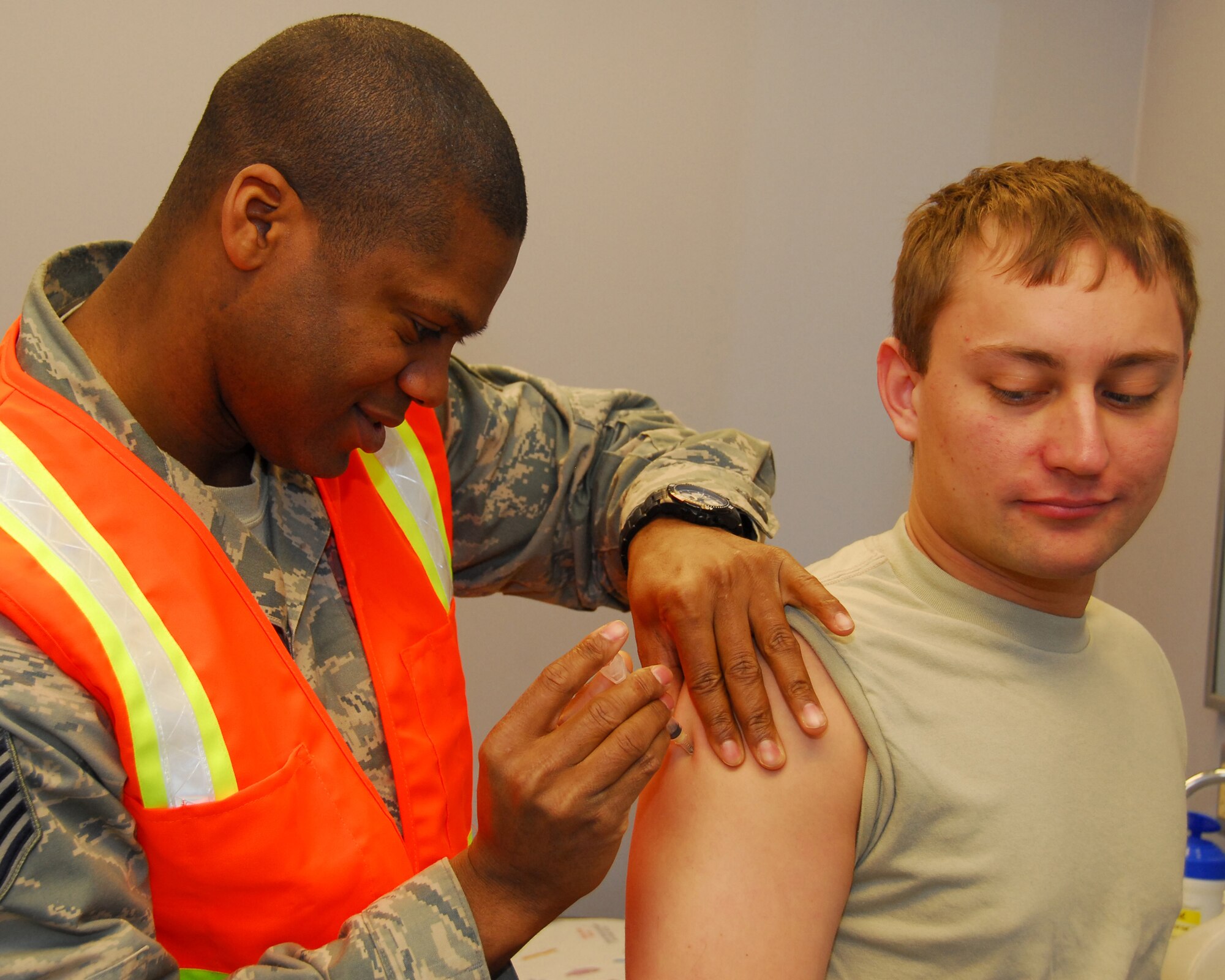 Tech. Sgt. Terrell Kelley simulates administering immunizations to Staff Sgt. Kurt Ziobro during Operational Readiness Exercise Golden Raven 10-2 March 21, 2010, Eielson Air Force Base, Alaska.  Sergeant Kelley is assigned the the 354th Medical Operations Squadron Immunization Clinic and Sergeant Ziobro is assigned to 354th Civil Engineering Squadron Explosive Ordnance Disposal flight. (U.S. Air Force photo/Staff Sgt. James Stewart)