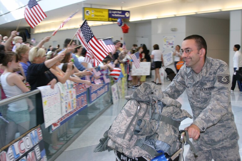 A member of the Maryland Air National Guard returns from Afghanistan to a cheering crowd at Baltimore Washington International Thurgood Marshall Airport Saturday, March 20, 2010. Loud cheers were heard as each of the 148 Airmen exited the international pier at the airport. The Guardsmen spent about three months in Afghanistan supporting Operation Enduring Freedom. (U.S. Air Force photo by Tech. Sgt. David Speicher/Released)