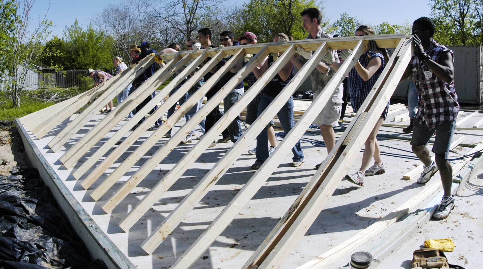 Cadets from the Air Force Academy lift the west wall of a home during a Habitat for Humanity project in Victoria, Texas, March 22, 2010. Cadets volunteered for the project as part of the Academy's Alternative Spring Break program. (U.S. Air Force photo/John Van Winkle)